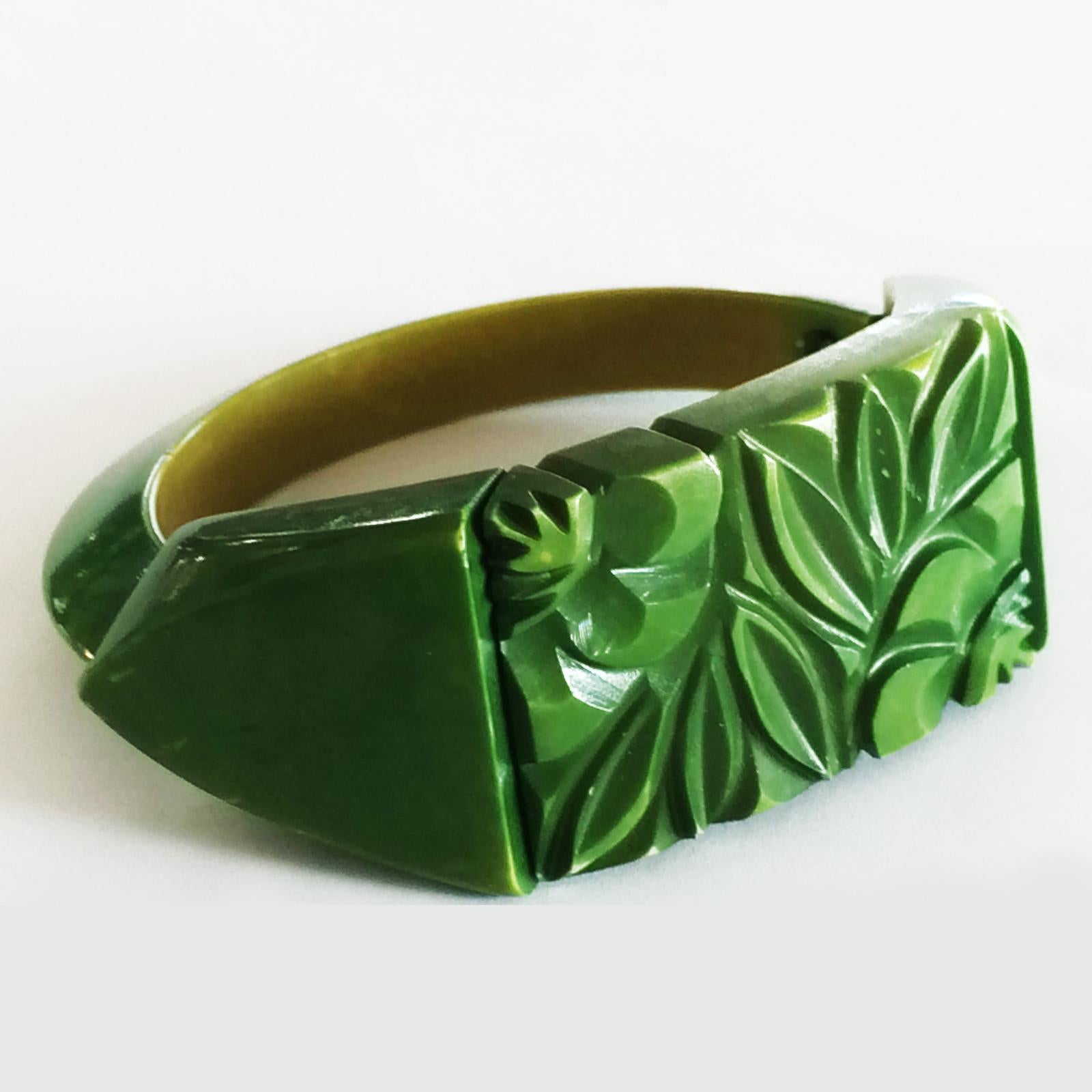 Art Deco French Bakelite, Green over stained on Yellow, Deeply Floral Carved and tapering to the rear. The Country of Origin stamped to rear of central carved area MADE IN FRANCE in a circle form. Stretch type to fit most sizes and the black bands