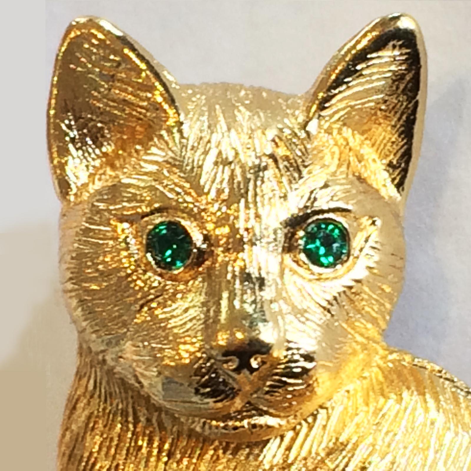 Mid Century Christian Dior Gilt metal  Cat Brooch with Emerald Green Glass Eyes. A high class Design by Christian Dior, with the Official Logo to a raised Lozenge to rear. Very attractive detail to the cats face, with a quality roll-over safety