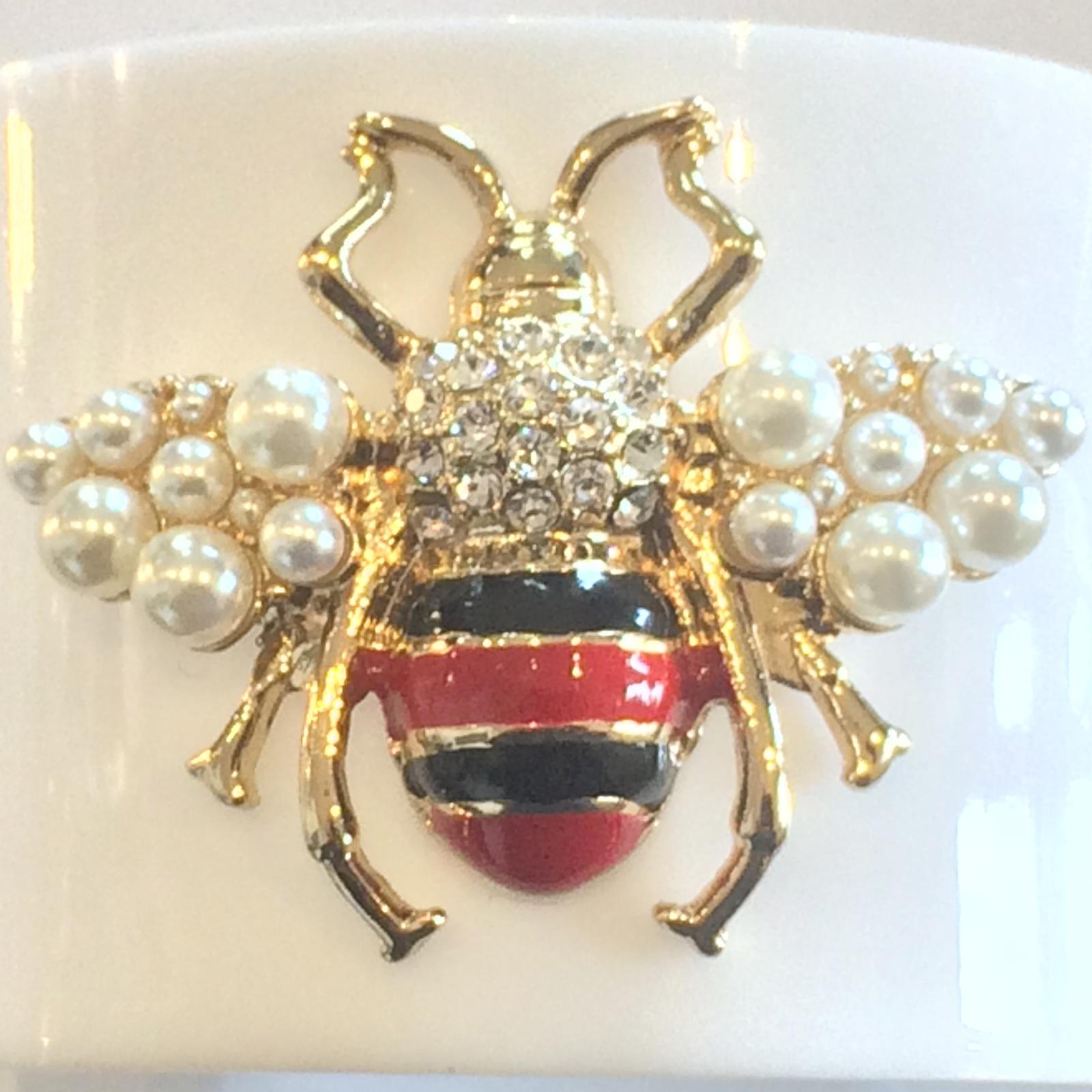 Authentic De La Renta White Lucite Cuff / Bangle and Bumble Bee in flight, with Gilt body and wings, rivetted to the Lucite for quality and strength. The lines are created in Red and Black enamel, brilliant Diamantes to the upper body  and wings