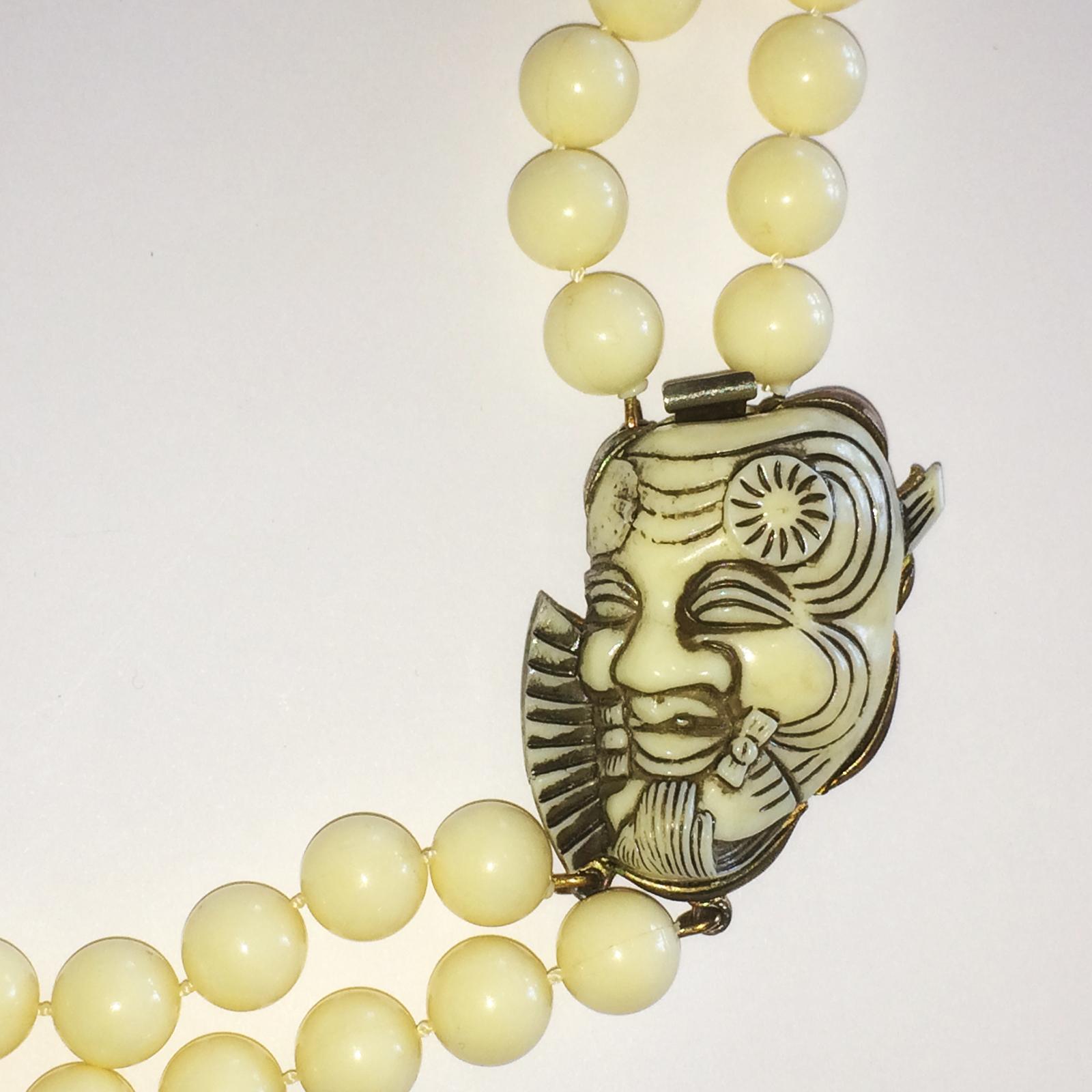 Art Deco Necklace Selro Selini Okina Devil Mask in cream Lucite with Pendant including Clasp in perfect working order on a double row of matching beads. SELINI Mark to raised bar on rear of Mask. All in excellent condition with no damage, no repairs