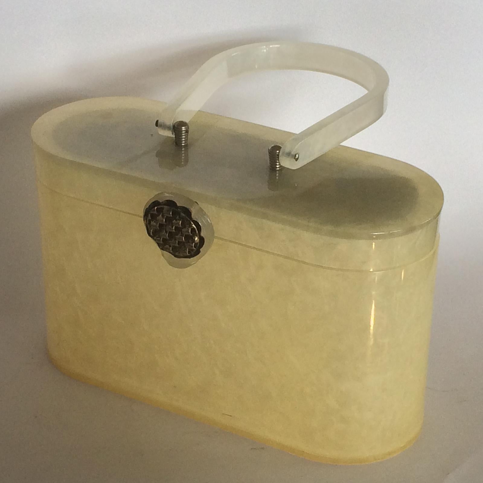 Art Deco Lucite Handbag with Mirror by Wilardy of U.S.A.. Impressive Cream clouds colour/Pattern, fitted internally with a mirror to the full lid area, and a gilt, fluted metal decoration to top of Clasp, in perfect original “snap” shut condition.