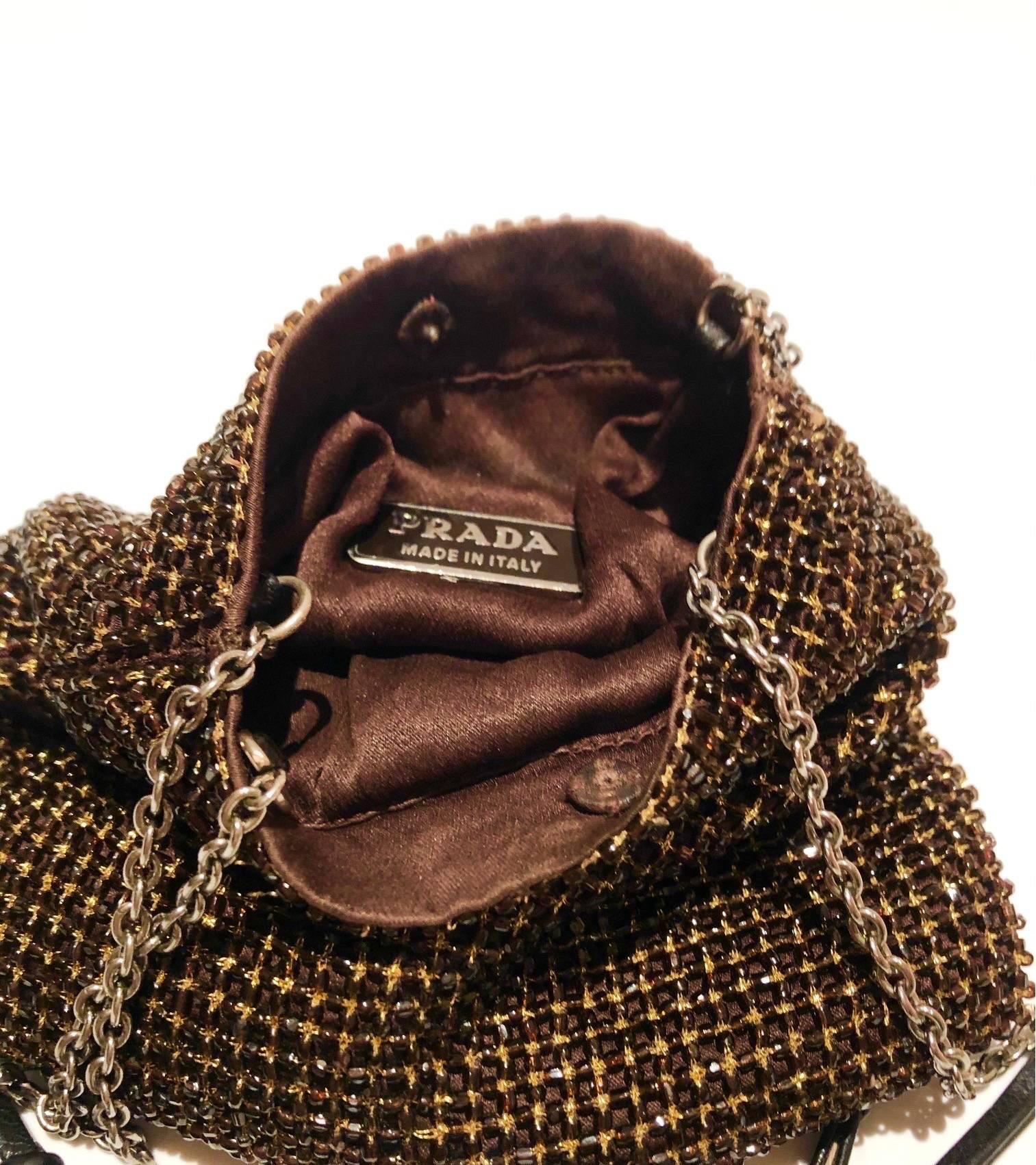 Unique Prada mini pouch crystal bag, top chain double handles, a front logo plaque, silver - tone hardware, crystal embellishments, a top button closure and an internal logo plaque, silky brown interior. 

Condition: 1990s, very good 
Measurements: