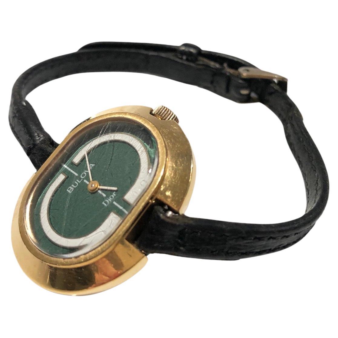 14K gold plated Dior by Bulova wrist wind up watch, fully working, green and white face, original black leather strap

Condition: Early 1970s, gold metal ware is in very good condition, watch face has some light scratches but no cracks, original