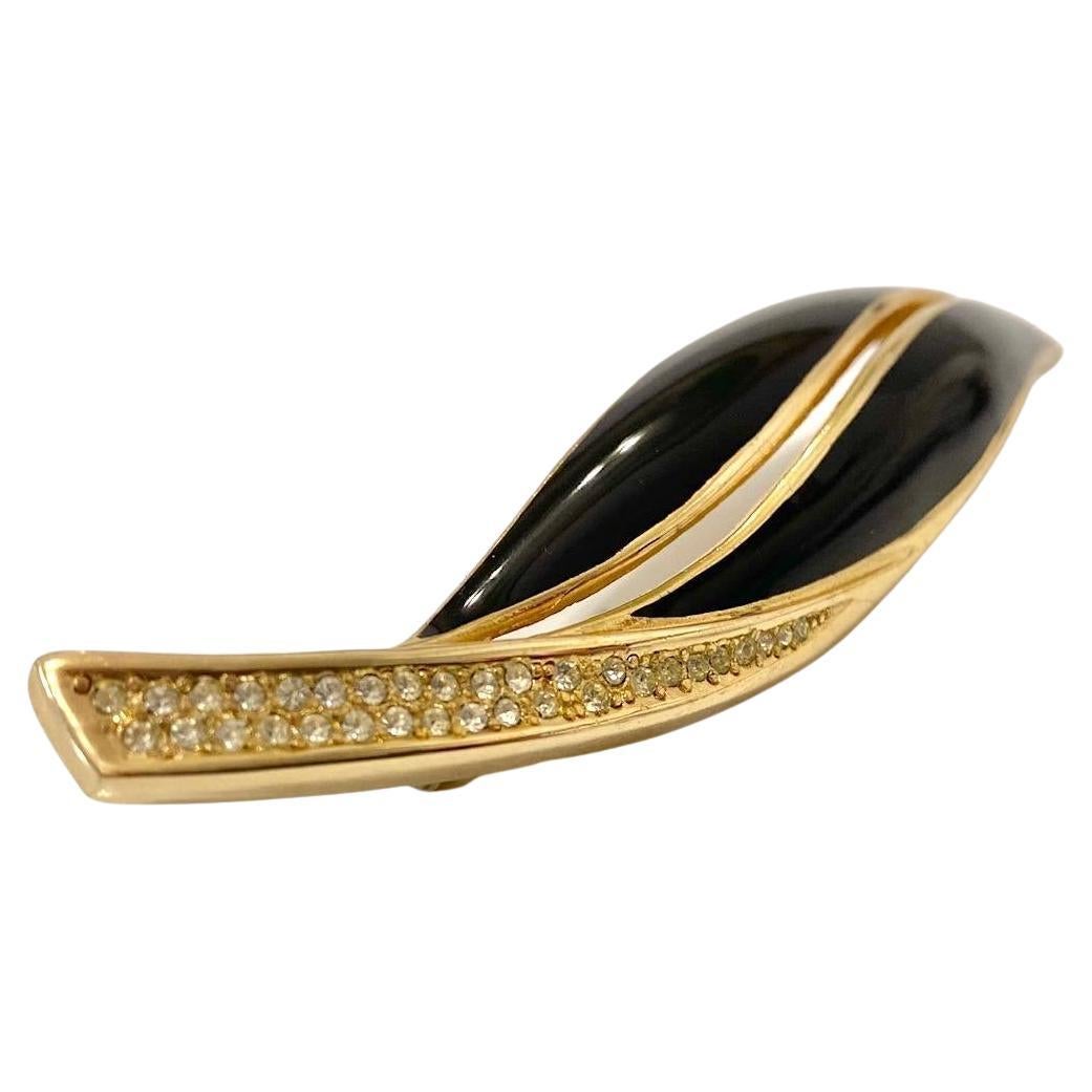 This 1980s Christian Dior Enamel Leaf Brooch,  yellow gold-plated brooch is an exquisite  piece featuring a sophisticated, stylish large leaf design, adorned with crystals, a signature 