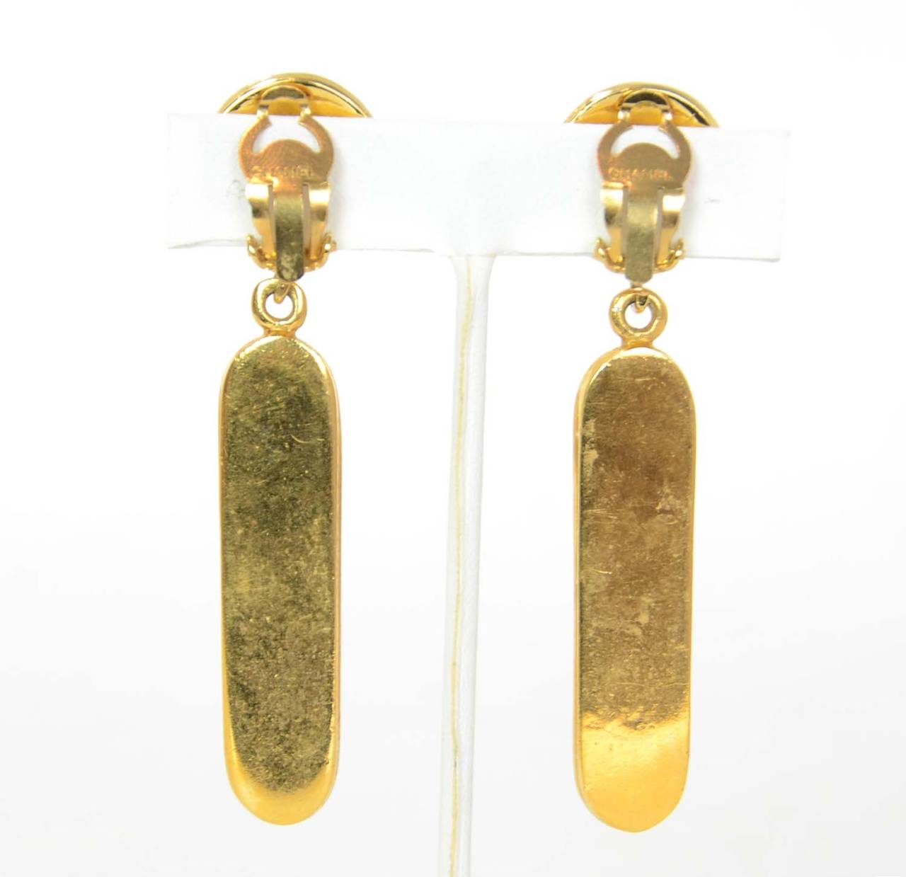 Chanel Gold Thermometer Dangling Earrings

*These are vintage earrings and are being sold AS-IS*

Made in: France
Year of Production: 1960s
Stamp: CHANEL
Closure: Clip-On
Color: Gold
Materials: Metal
Overall Condition: One of the