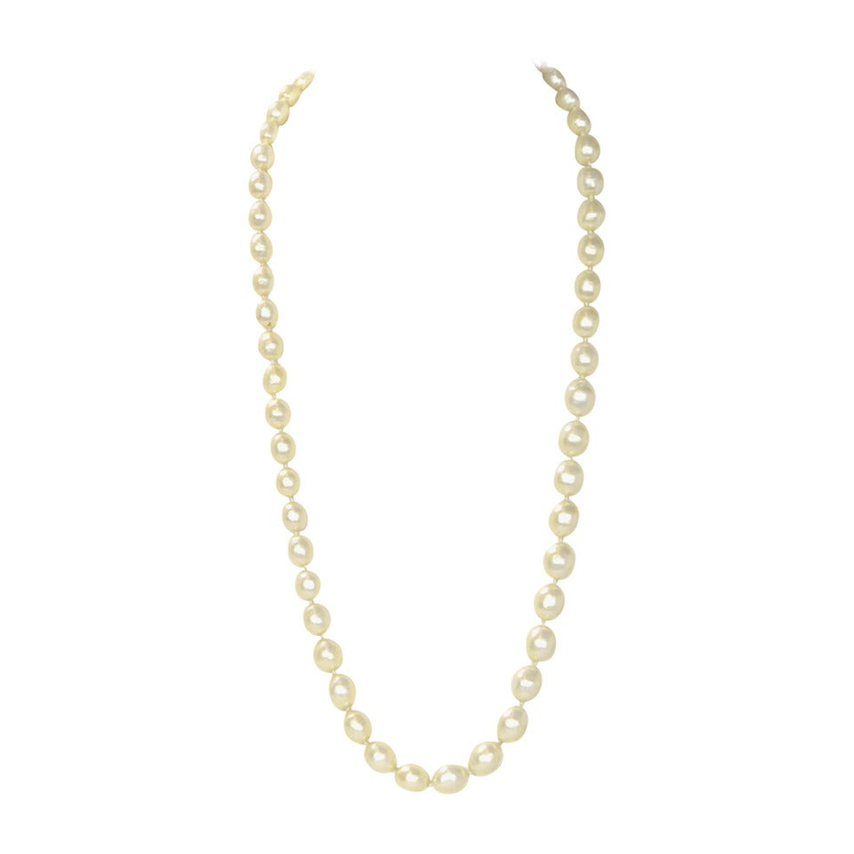 Chanel Vintage '87 Graduated Pearls Single Strand Necklace

Made in: France
Year of Production: 1987
Stamp: 2 CC 6
Closure: None
Color: Ivory
Materials: Faux pearls
Overall Condition: Excellent with the exception of some minor nicks to some of the