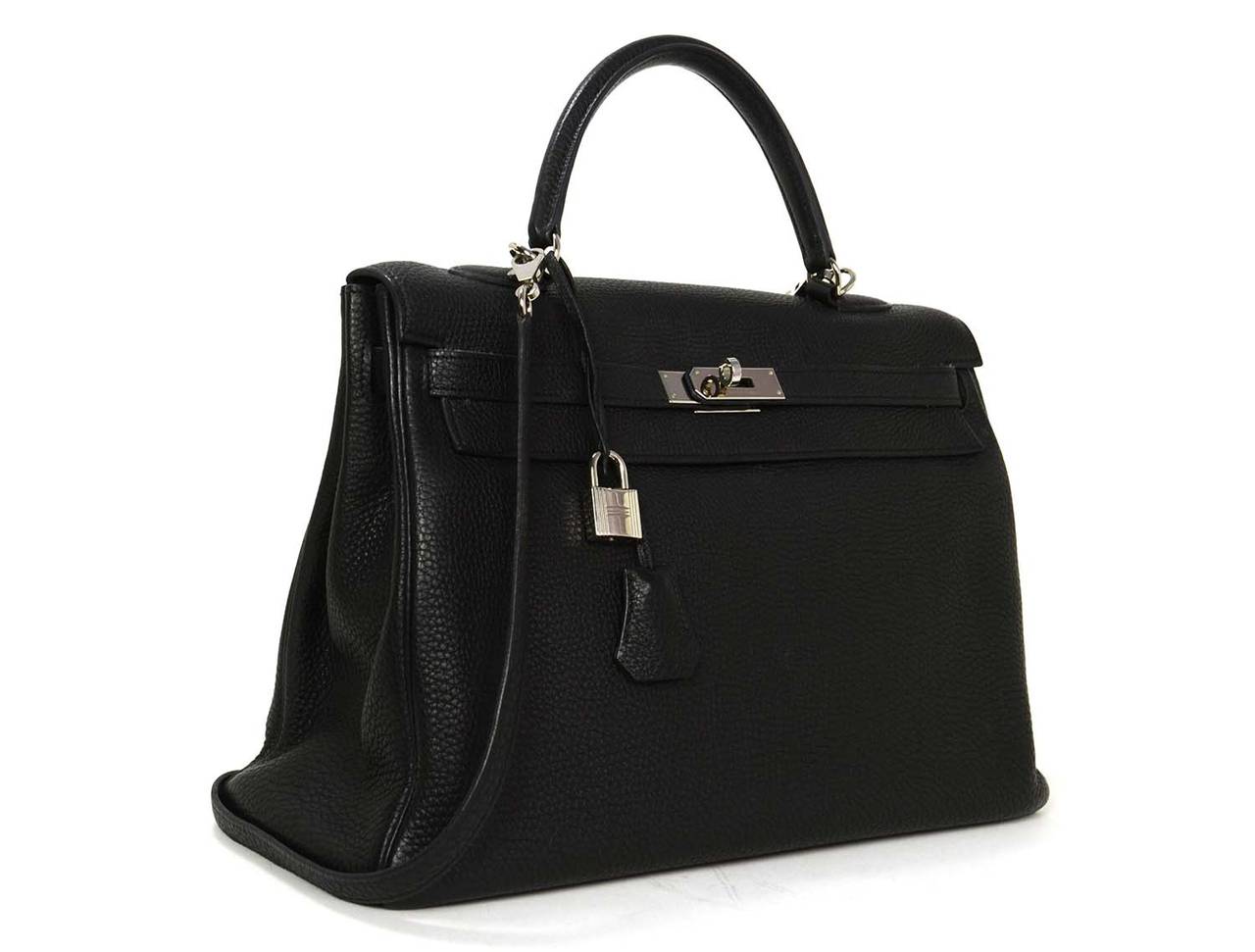 This iconic bag is finely crafted of togo leather in classic black and features a sturdy reinforced leather top handle, a frontal flap, optional shoulder strap and palladium hardware. This chic handbag is a beautiful compliment to any day or evening