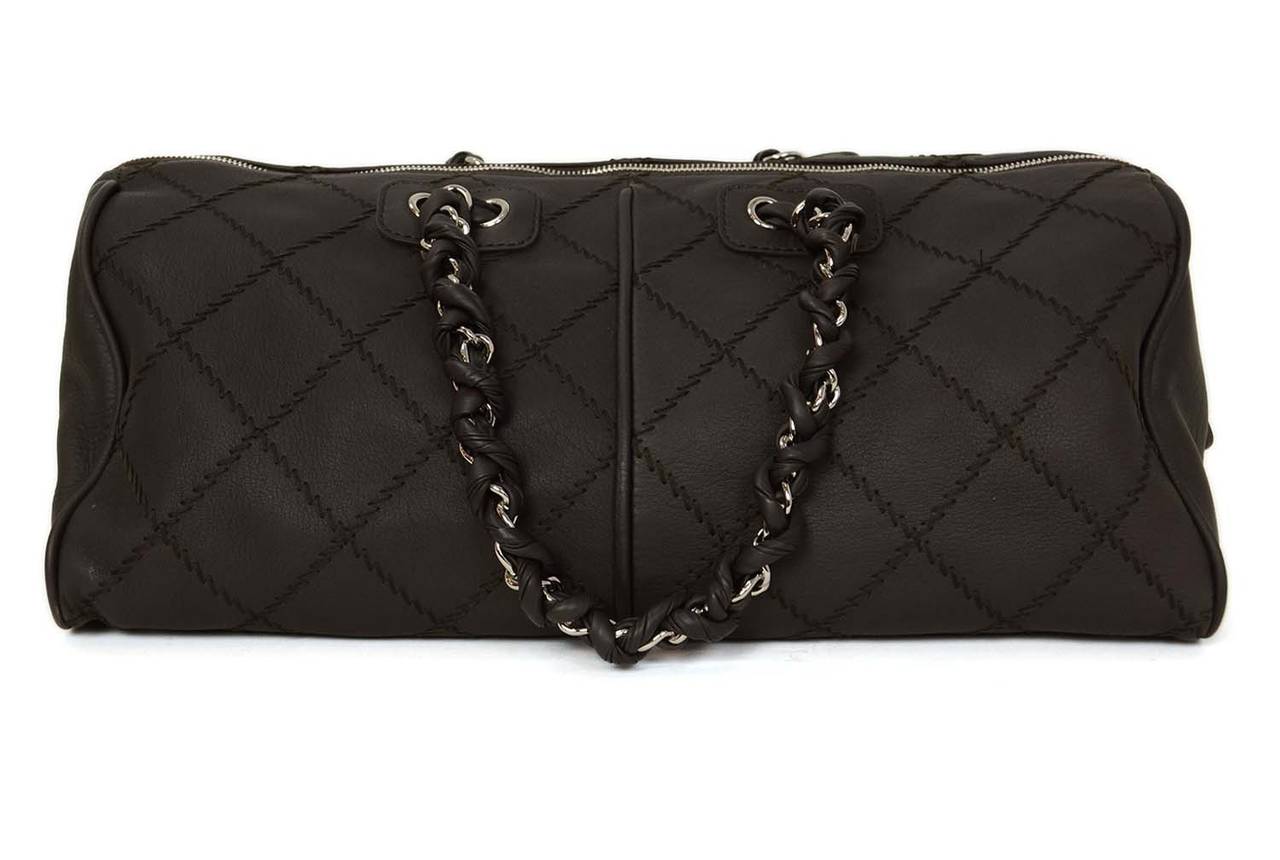 Features two braided handles and zig-zag quilting detail.
-Made in: France
-Year of Production: 2012
-Color: Brown
-Hardware: Silvertone
-Materials: Leather
-Lining: Black textile
-Closure/opening: Zip top w/ CC charm zipper pull
-Exterior