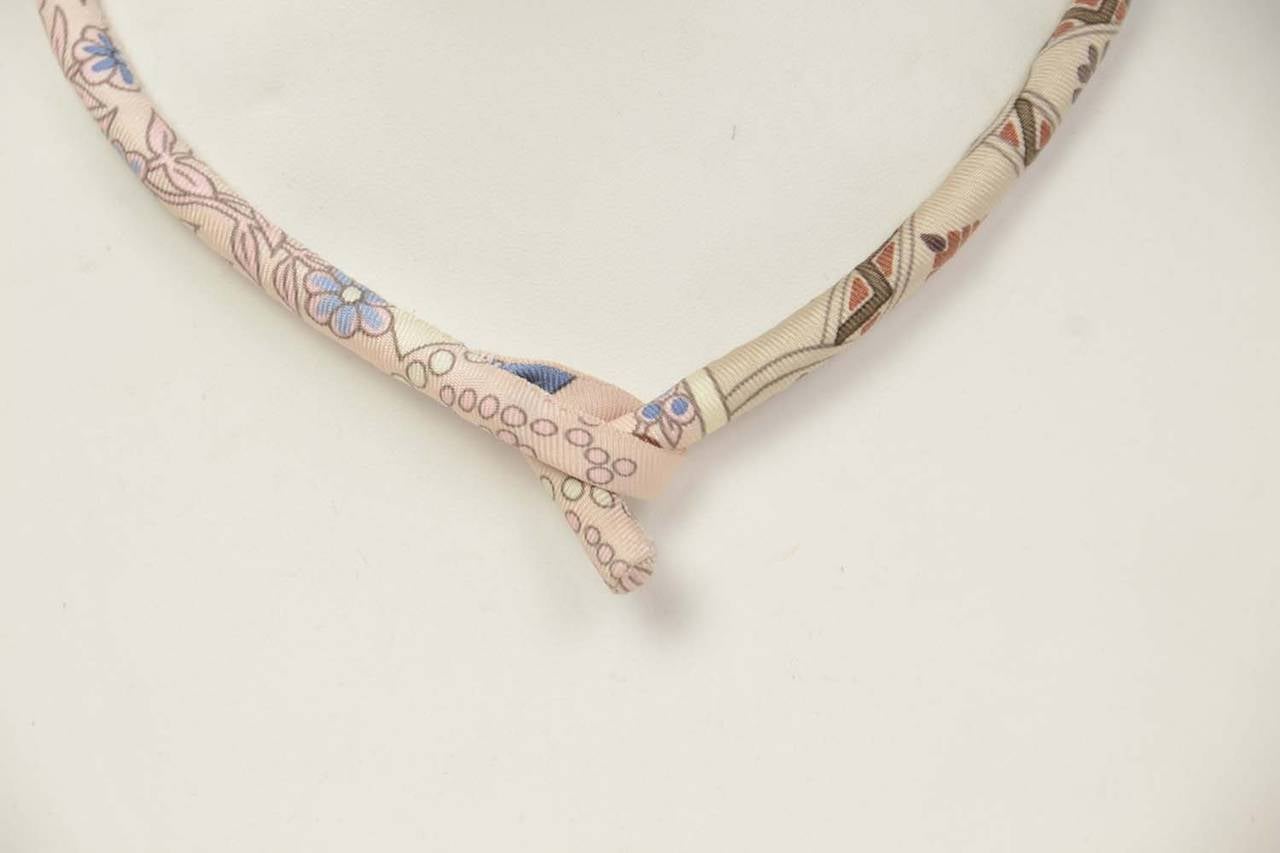 HERMES Petit H Silk Print Choker/Wrap Bracelet

    Made in: France
    Year of Production: 2010-2014
    Closure: Toggle closure
    Color: Pink silk print
    Materials: Silk
    Overall Condition: Excellent pre-owned