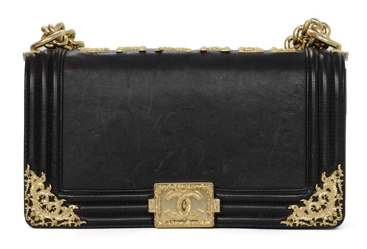 c.2013
Chanel Black Medium Boy Bag with Filagre Detail

Made in: Italy
Year of Production: 2013
Color: Black
Hardware: Brushed goldtone
Materials: Leather, metal
Lining: Beige textile
Closure/opening: Front flap with signature Boy