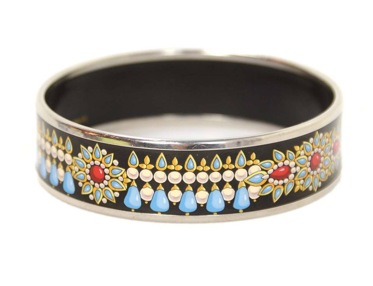 HERMES Black Enamel Bangle W/Blue and White Designs RT $635

    Made in: Austria
    Stamp: K
    Closure: Slips on over hand
    Color: Black, blue, and white
    Materials: Enamel Palladium
    Overall Condition: Excellent condition, some
