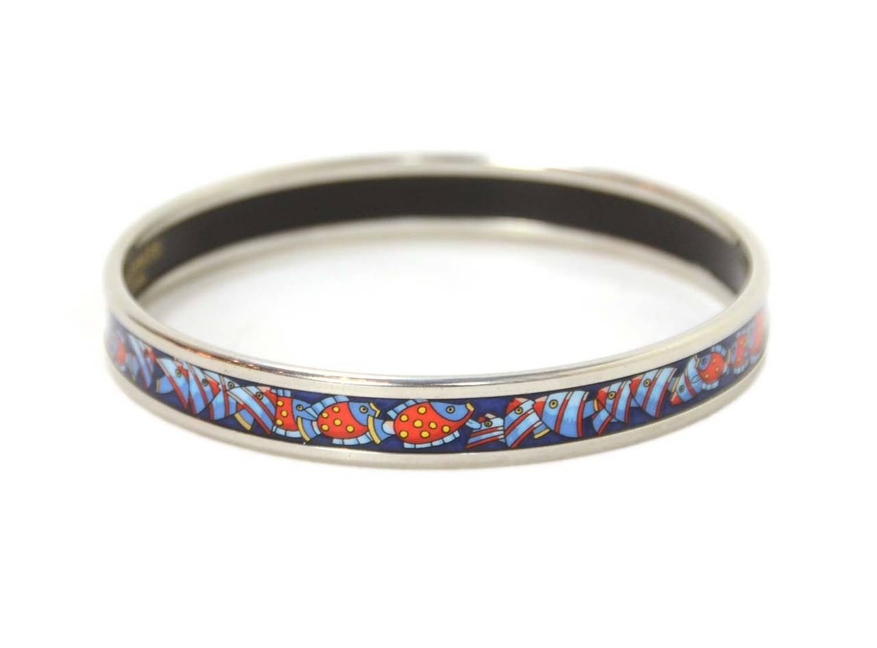HERMES Blue Thin Enamel Bangle With Red Fish

    Made in: Austria
    Stamp: J
    Closure: Slips on over the hand
    Color: Blue enamel with red fish and palladium trim
    Current retail: $525
    Materials: Enamel & Palladium
   