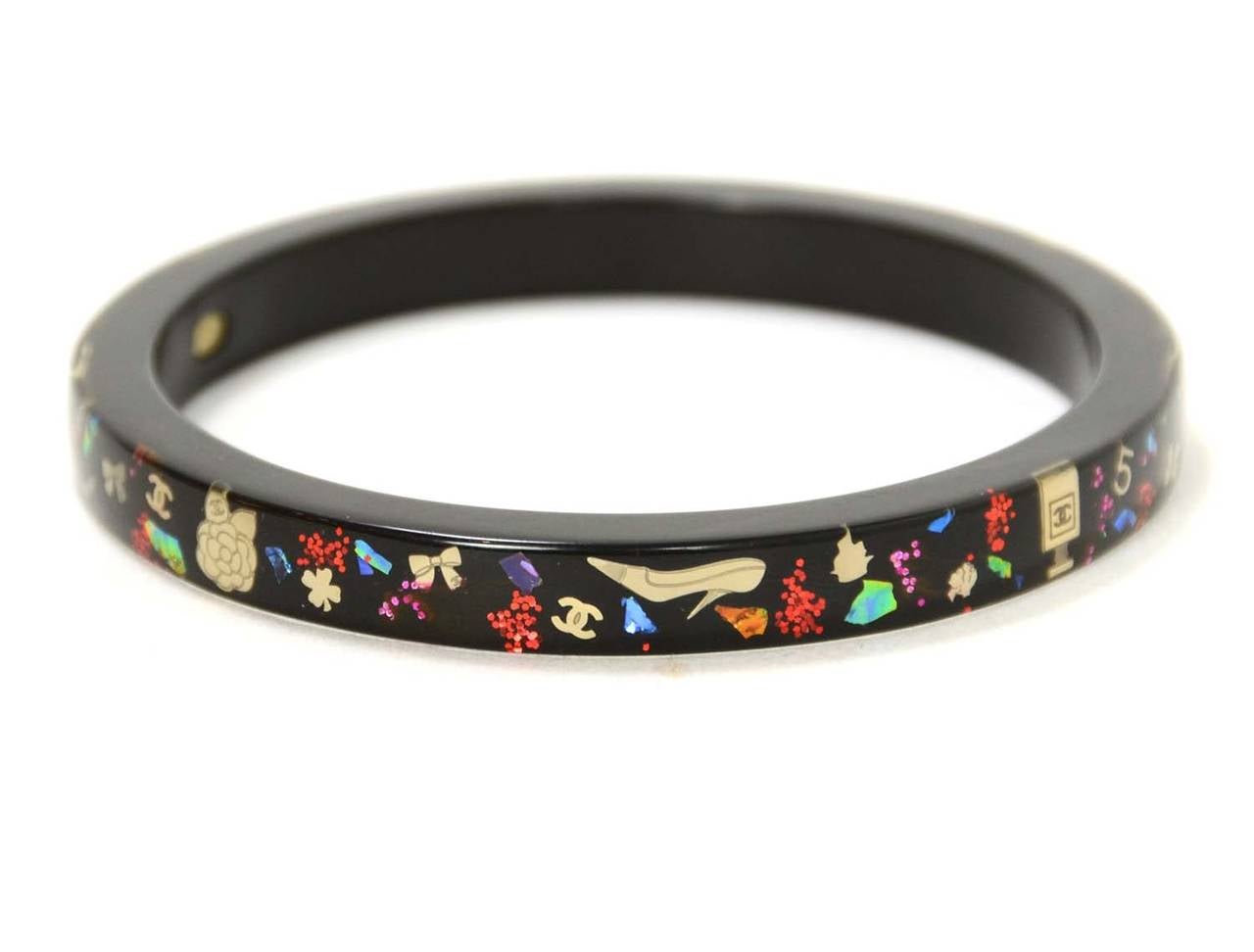 Chanel Black Resin Bangle W/ Metallic Inlay

    Made in: France
    Year of Production: 2006
    Stamp: CHANEL 06 A Made In France
    Closure: Slips on over hand
    Color: Black
    Materials: Resin
    Overall Condition: Excellent