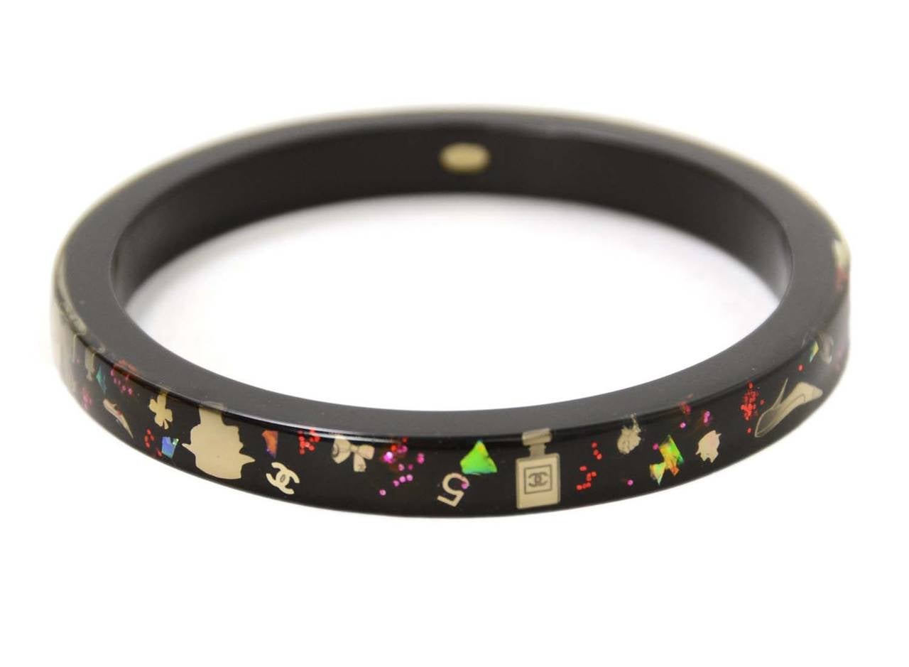 Chanel Black Resin Bangle W/ Metallic Inlay

    Made in: France
    Year of Production: 2006
    Stamp: CHANEL 06 A Made In France
    Closure: Slips on over hand
    Color: Black
    Materials: Resin
    Overall Condition: Excellent