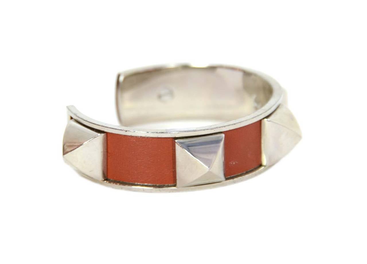 HERMES Vintage Brick Leather Medor Stud Cuff PHW
Stamp: HERMES
Closure: Slips on over wrist
Color: Brick leather with palladium hardware
Materials: Leather with palladium hardware
Overall Condition: Good Vintage condition, some scratches to the