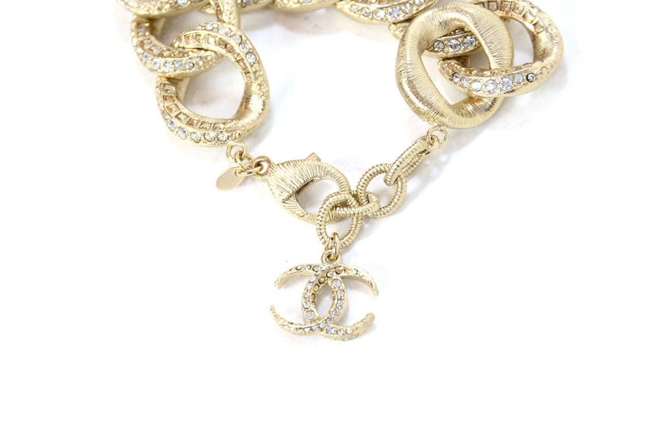 Features clear circle crystals and champagne colored square shaped crystals. Hanging CC charm also encrusted in clear and champagne circle rhinestones.

-Made in: Italy
-Year of Production: 2015
-Stamp: CHANEL 15C MADE IN ITALY
-Closure: