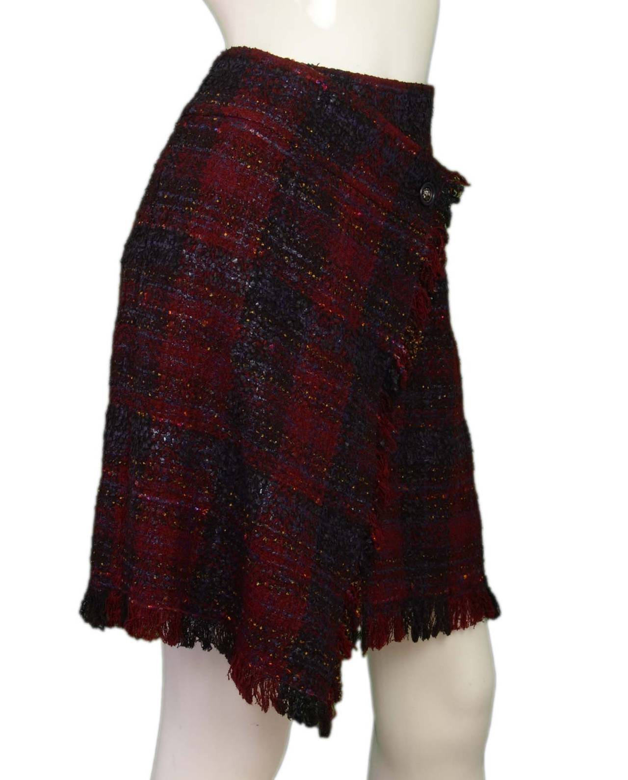 Features tweed trim and single Chanel lion head button

-Made in: Italy
-Year of Production: After 2010
-Color: Red, blue, with some minor yellow accents
-Composition: 63% wool, 35% nylon, 1 polyester, 1% rayon
-Tags: CHANEL CC
-Lining: 100%