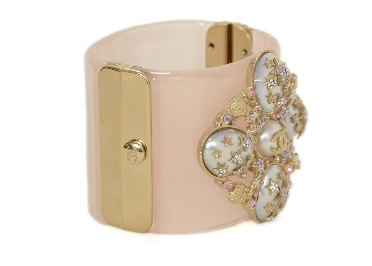 Chanel 2012 Blush Clamper Cuff 
Features grey faux pearl with light purple rhinestone stars and pink rhinestone accents. Light goldtone center CC.
Made in: Italy
Year of Production: 2012
Stamp: CHANEL B12 CC P MADE IN ITALY
Closure: Hinge and