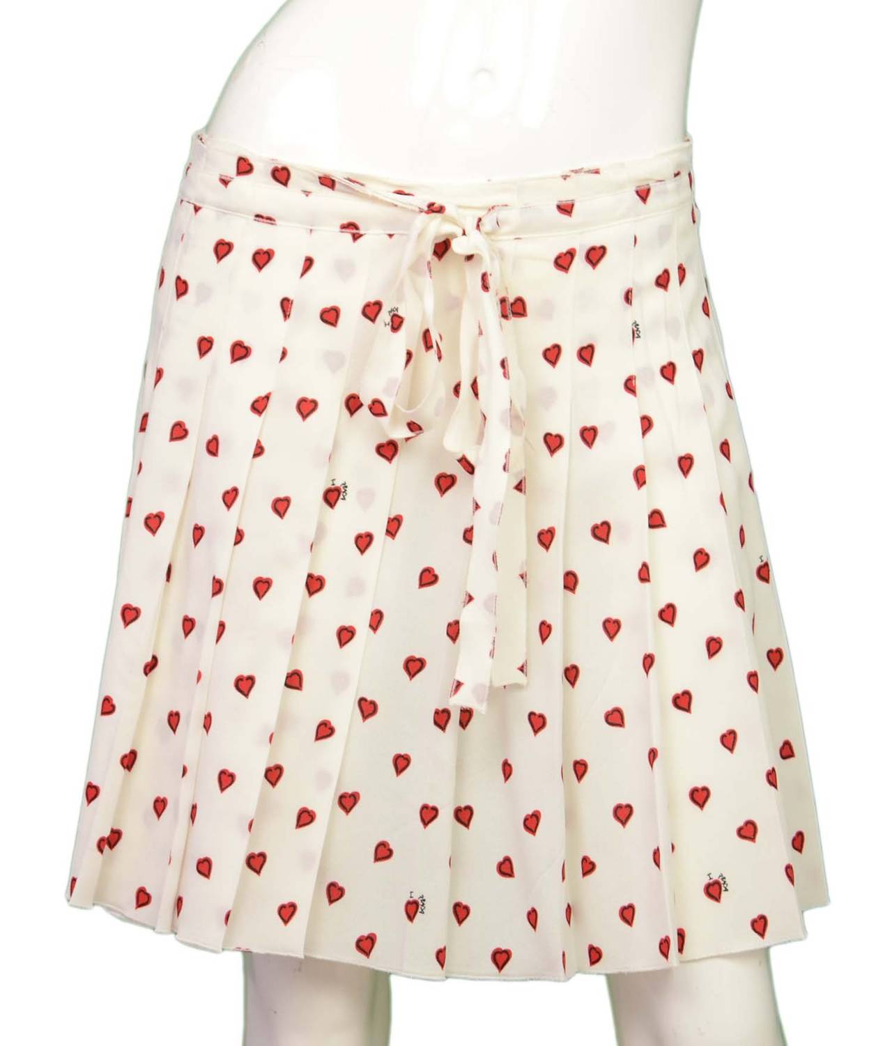 Prada Silk Pleated Skirt w/Heart Print
Features 'I (heart symbol) Prada' text throughout print on skirt

    Made in: Italy
    Color: White red and black
    Composition: 98% viscose, 2% other fibers
    Lining: None
    Closure/opening: