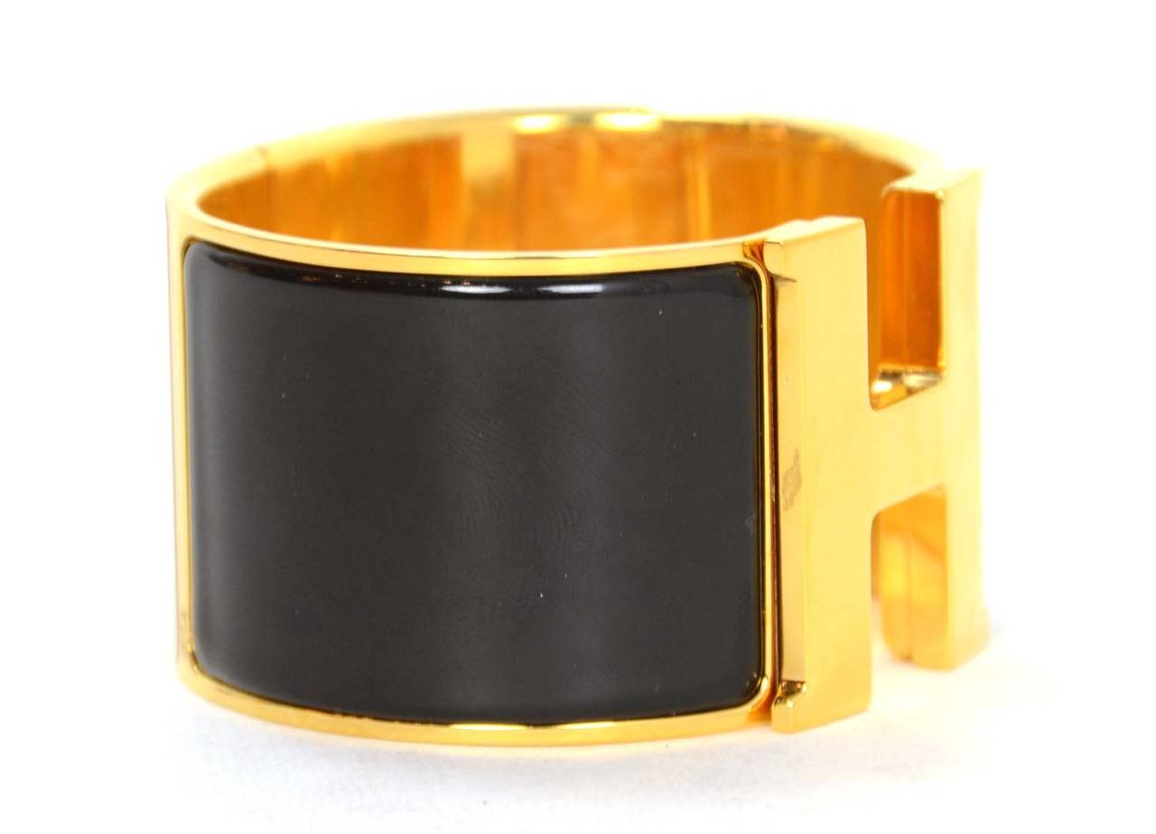 HERMES Black and Gold Extra-Wide Clic-Clac H Bracelet

    Made in: France
    Stamp: HERMES Made In France
    Closure: Classic clic-clac closure
    Color: Black and gold
    Materials: Enamel and Metal
    Overall Condition: Excellent