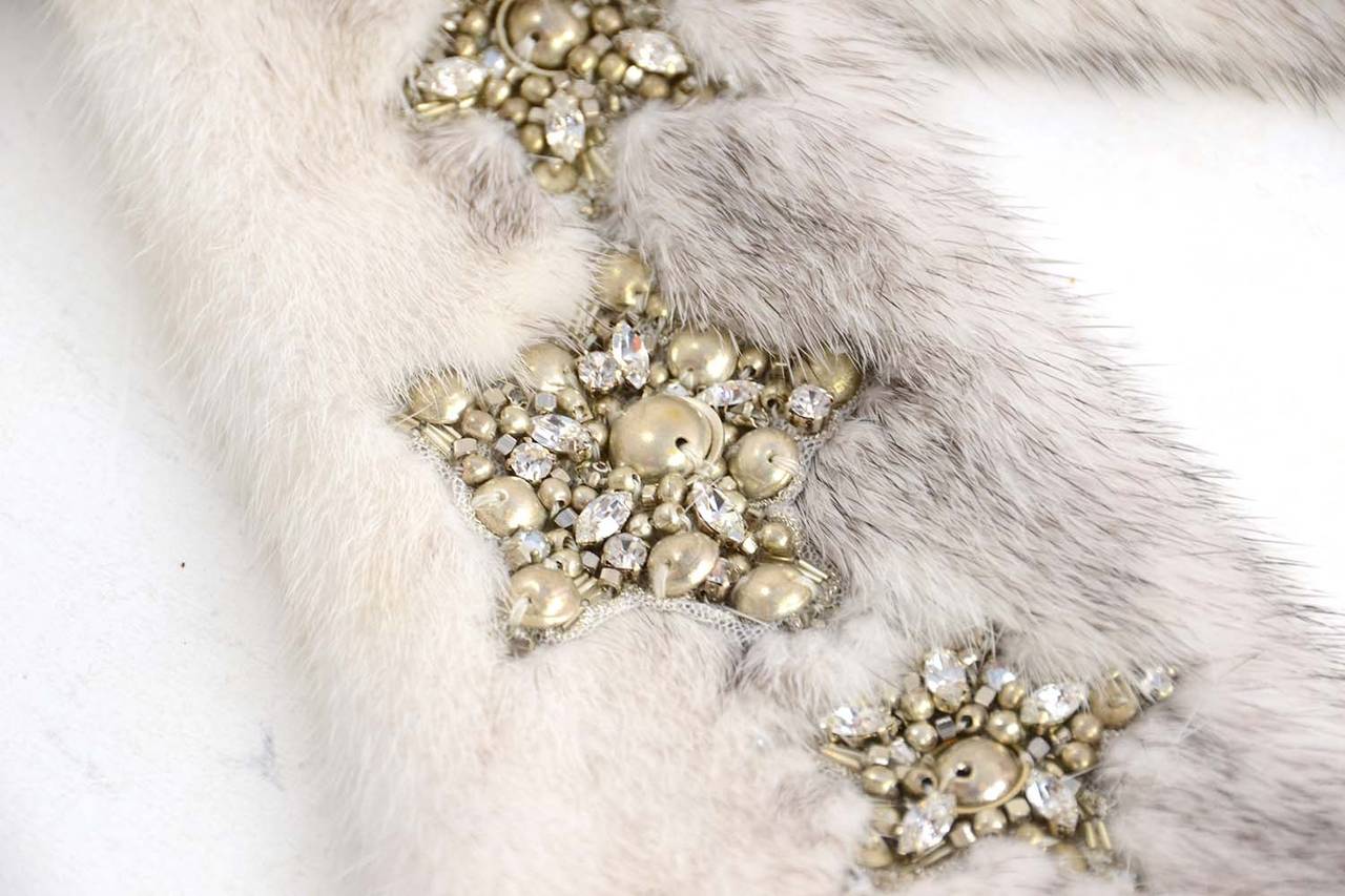 J. Mendel Grey/White Mink Fur Collar w/Beading Accent
Features four rhinestone and silver beaded star patches

    Made in: U.S.A
    Color: White, grey, and silver
    Composition: 100% Fur
    Lining: 100% white silk
    Closure/opening: