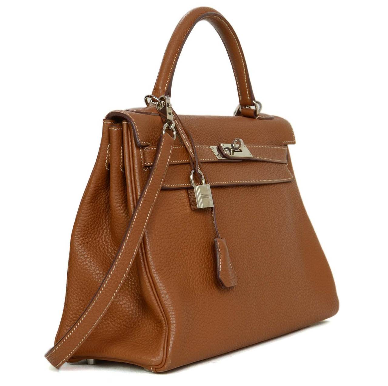 Hermes 2011 Gold Clemence Leather Kelly Bag 32 cm
Features souple clemence leather for more movement and a softer appearance to the bag

    Made in: France
    Year of Production: 2011
    Color: Golden brown, palladium, and white contrast