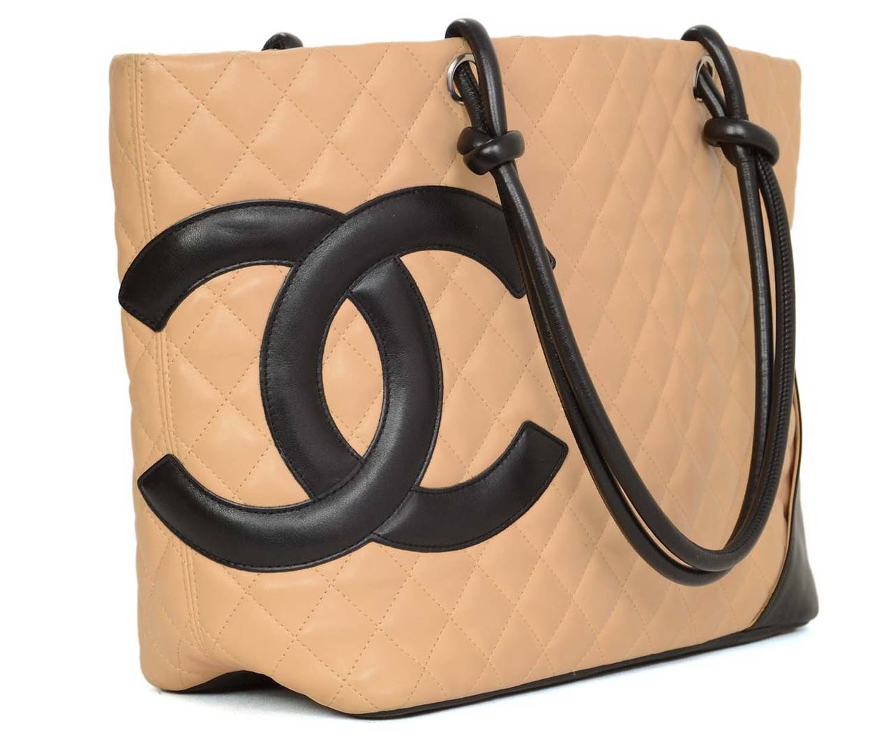 CHANEL Tan/Black Quilted Leather Large Cambon Tote Bag
Features interior leather strap with lobster clasp, a cellphone holder and two pen holders

    Made in: France
    Year of Production: 2004-2005
    Color: Tan and black
    Hardware: