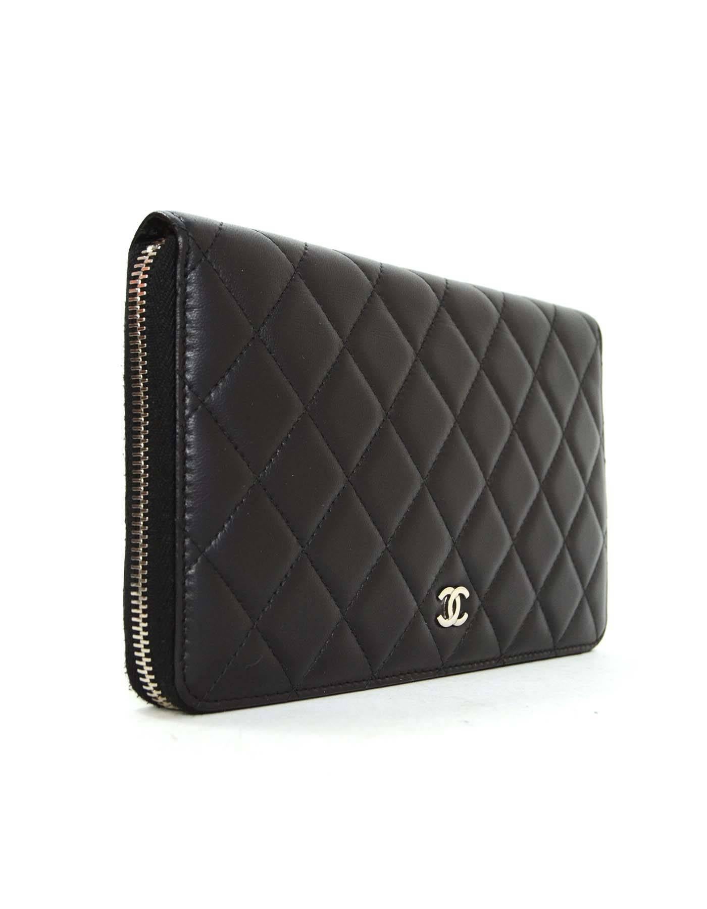 Chanel Black Lambskin Quilted Large Zip Wallet SHW
Features lambskin leather with a silver hardware CC logo

Made in: Italy
Year of Production: 2012-2013
Color: Black
Hardware: Silvertone
Materials: Lambskin
Lining: Burgundy