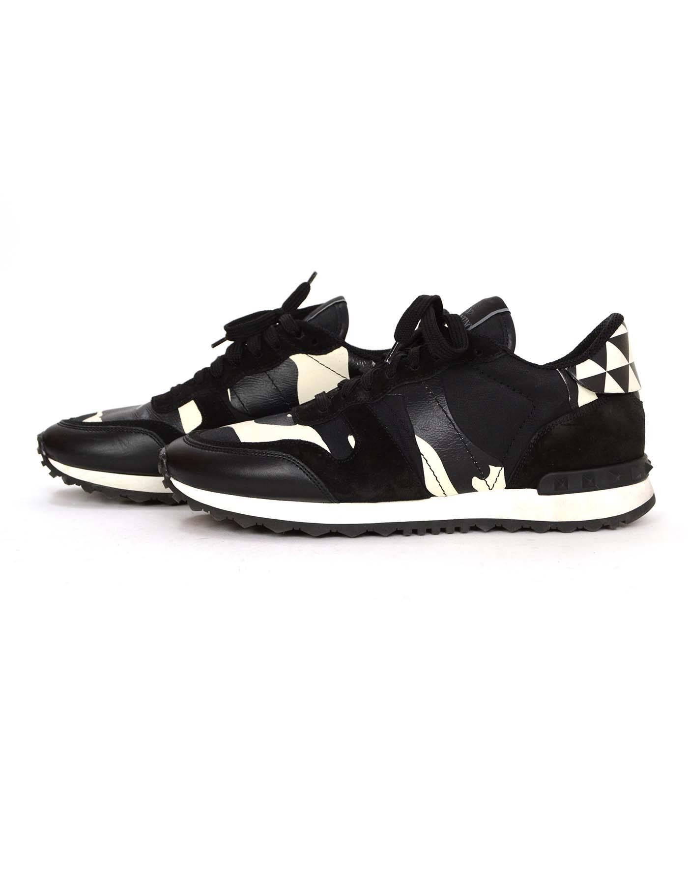 Valentino Black & White Camo Ltd. Ed. Sneakers sz 40
Features a camo print and stacked triangle pattern with studs on the heel

Made In: Italy
Year of Production: 2015
Color: Black and white
Materials:  Leather, suede and rubber
Lining: Black