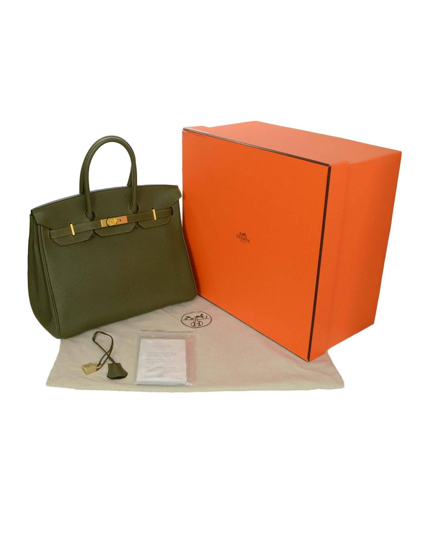 Hermes Olive Green Togo Special Order 35cm Birkin Bag ﻿
Features a horse shoe stamp, signifying that it is a special order. Has brushed gold hardware, and contrasting orange stitching
Made In: France
Year of Production: 2010
Color: Olive