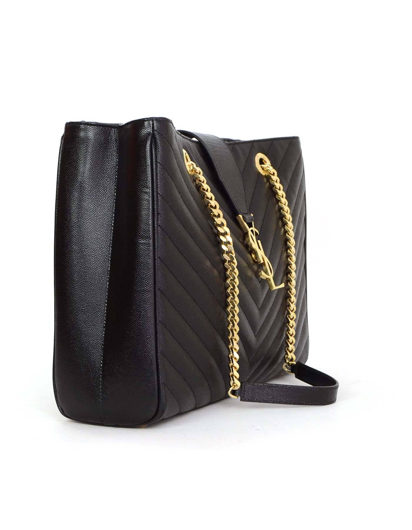 Saint Laurent Black Leather Chevron Monogram Shopper Tote Bag GHW
Features YSL logo medallion flap with magnetic snap close and a double curb-chain strap with leather shoulder rest

Made In: Italy
Color: Black
Hardware: Goldtone
Materials: