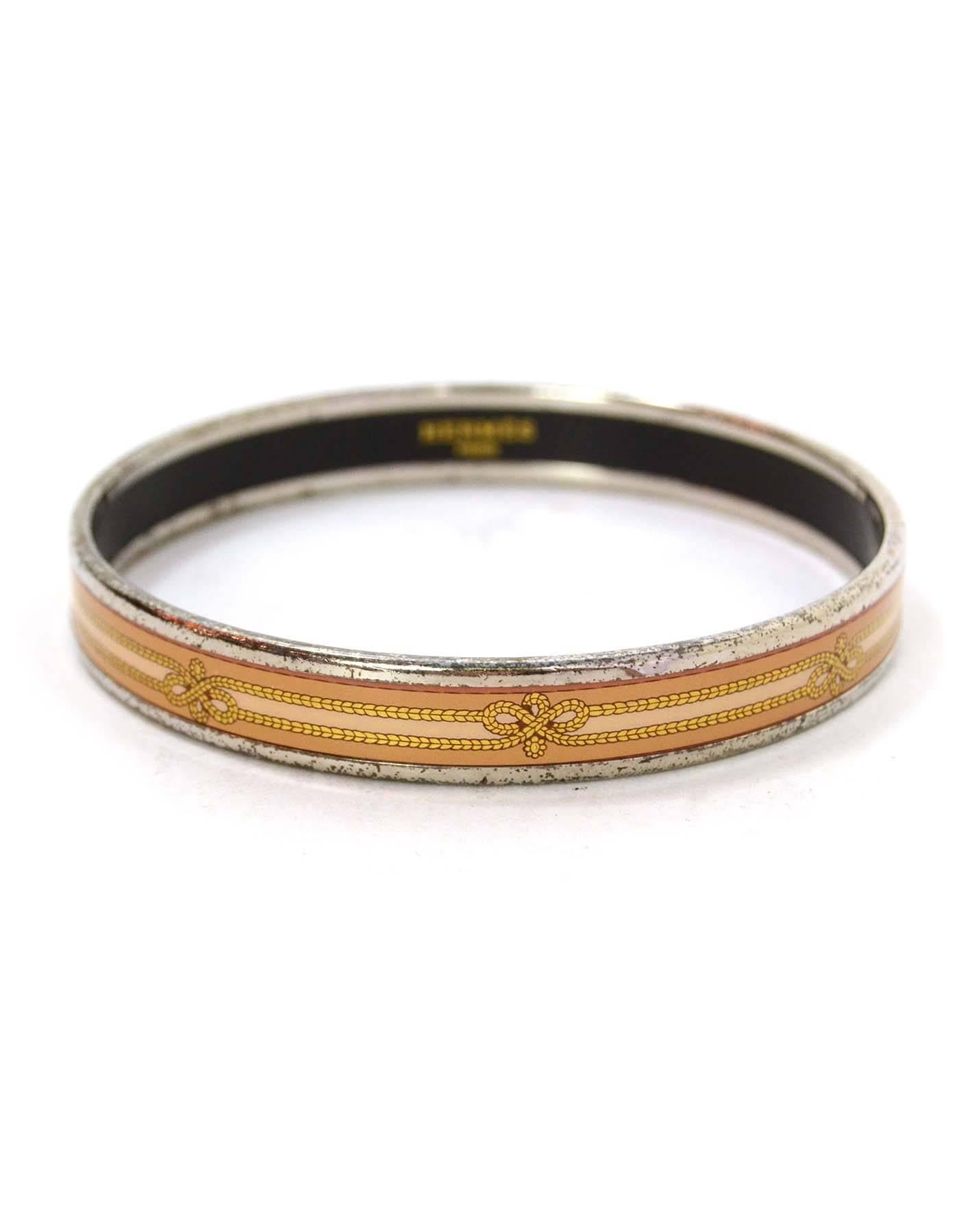 Hermes Narrow Printed Enamel Bangle 
Features peach and bronze rope printed throughout
Made In: Austria
Color: Peach, bronze and silvertone
Hardware: Palladium
Materials: Enamel and metal
Closure: None
Stamp: Made in Austria + I
Retail