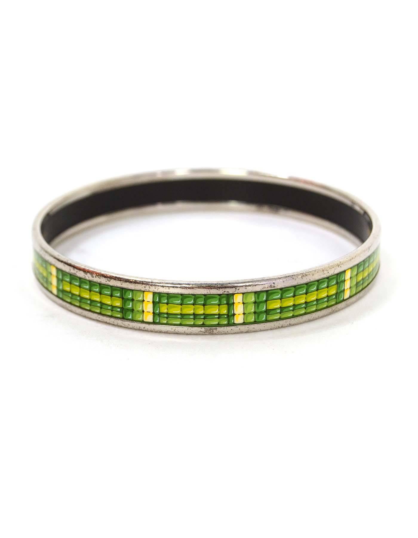 Hermes Narrow Printed Enamel Bangle 
Features green and yellow tiles printed throughout
Made In: Austria
Color: Green, yellow, and silvertone
Hardware: Palladium
Materials: Enamel and metal
Closure: None
Stamp: Made in Austria + K
Retail