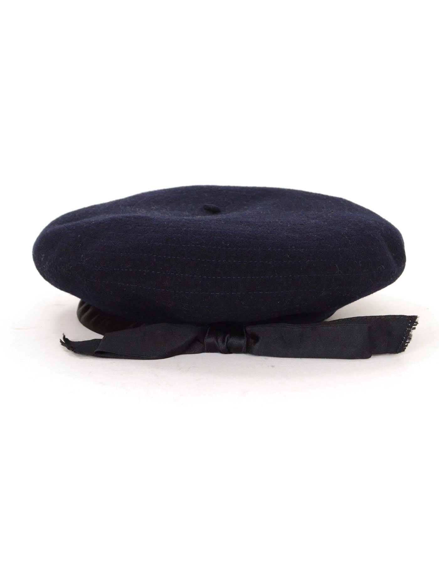 Chanel Vintage '70s Navy Wool Beret Hat 
Features black bow ribbon trim detail

Color: Navy and black 
Composition: Wool 
Lining: None
Overall Condition: Excellent pre-owned vintage condition with the exception fraying of bow detail, missing