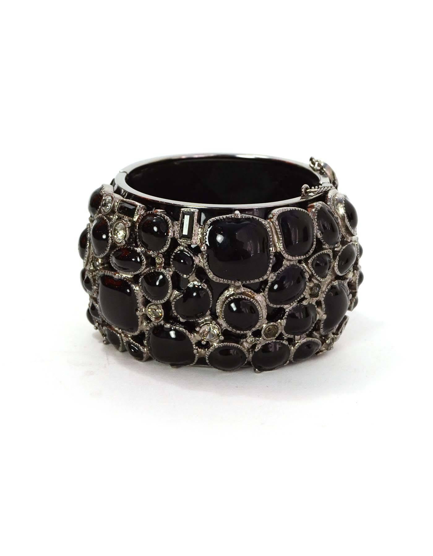 Chanel Black Enamel & Crystal Cuff Bracelet
Features large CC logo encrusted on center.  Front of bracelet can be worn as enamel cluster, or with CC visible.

Made In: France
Year of Production: 2009
Color: Black, silvertone and
