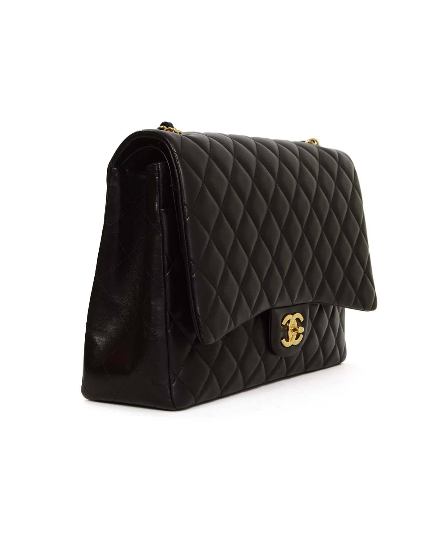 Chanel Black Quilted Lambskin Maxi Classic Flap Bag GHW
Features adjustable shoulder strap and single flap

Made in: France
Year of Production: 2014
Color: Black and goldtone
Hardware: Goldtone
Materials: Leather and metal
Lining: Black and burgundy