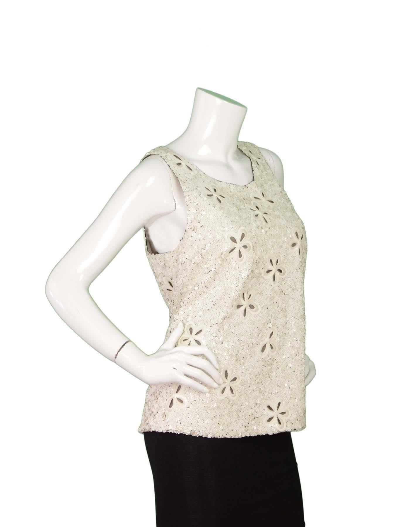 Chanel Floral Sequin Sleeveless Top 
Features flower cut outs with black mesh underlay
Made In: France
Year of Production: 2011
Color: Ivory and black
Composition: 100% silk
Lining: Nude, 100% silk
Closure/Opening: Back center zip up with