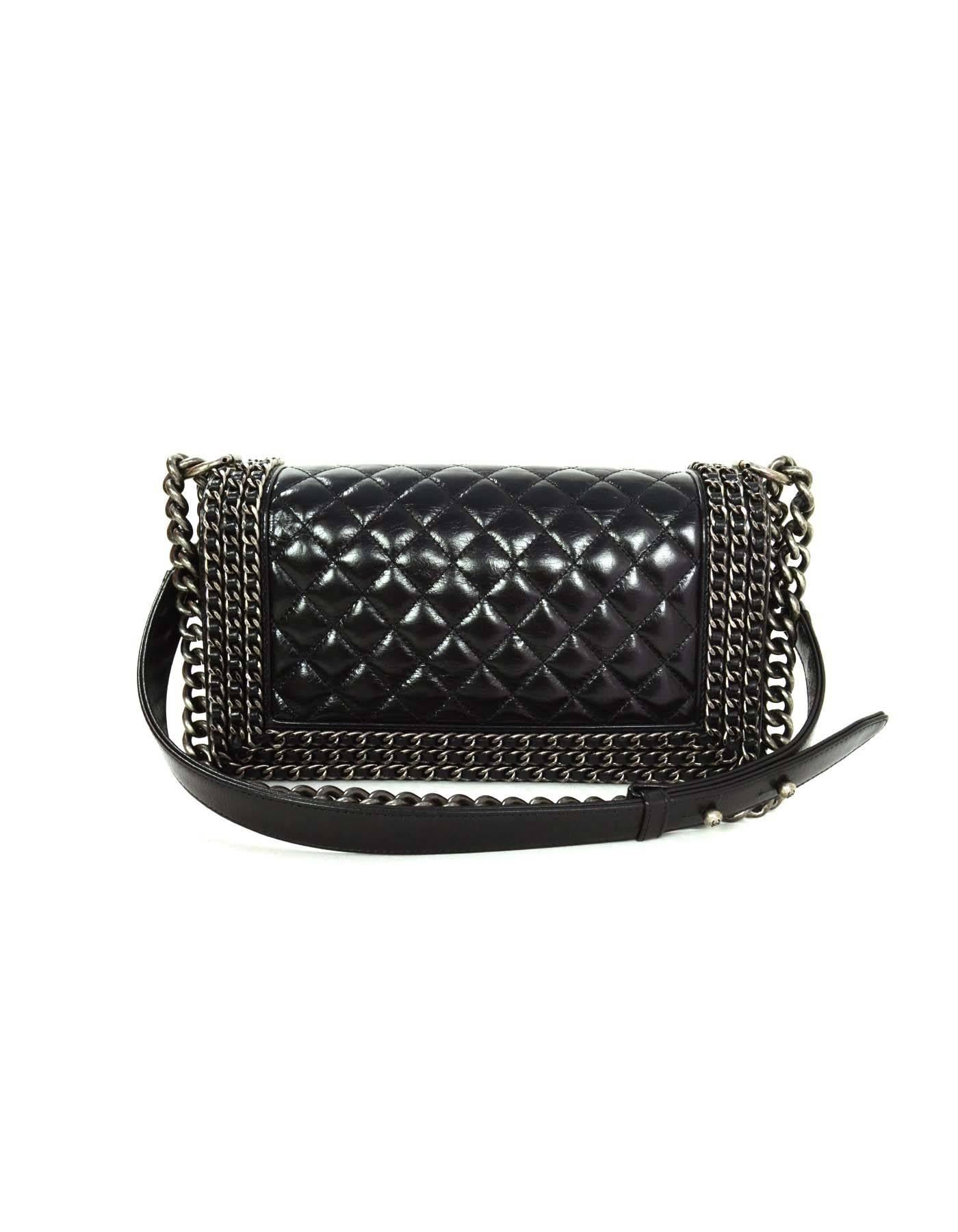 Chanel '15 Black Distressed Chain Around Medium Boy Bag 
Features triple black leather woven chain framing flap top
Made In: Italy
Year of Production: 2015
Color: Black
Hardware: Oxidized silvertone
Materials: Leather and metal
Lining: