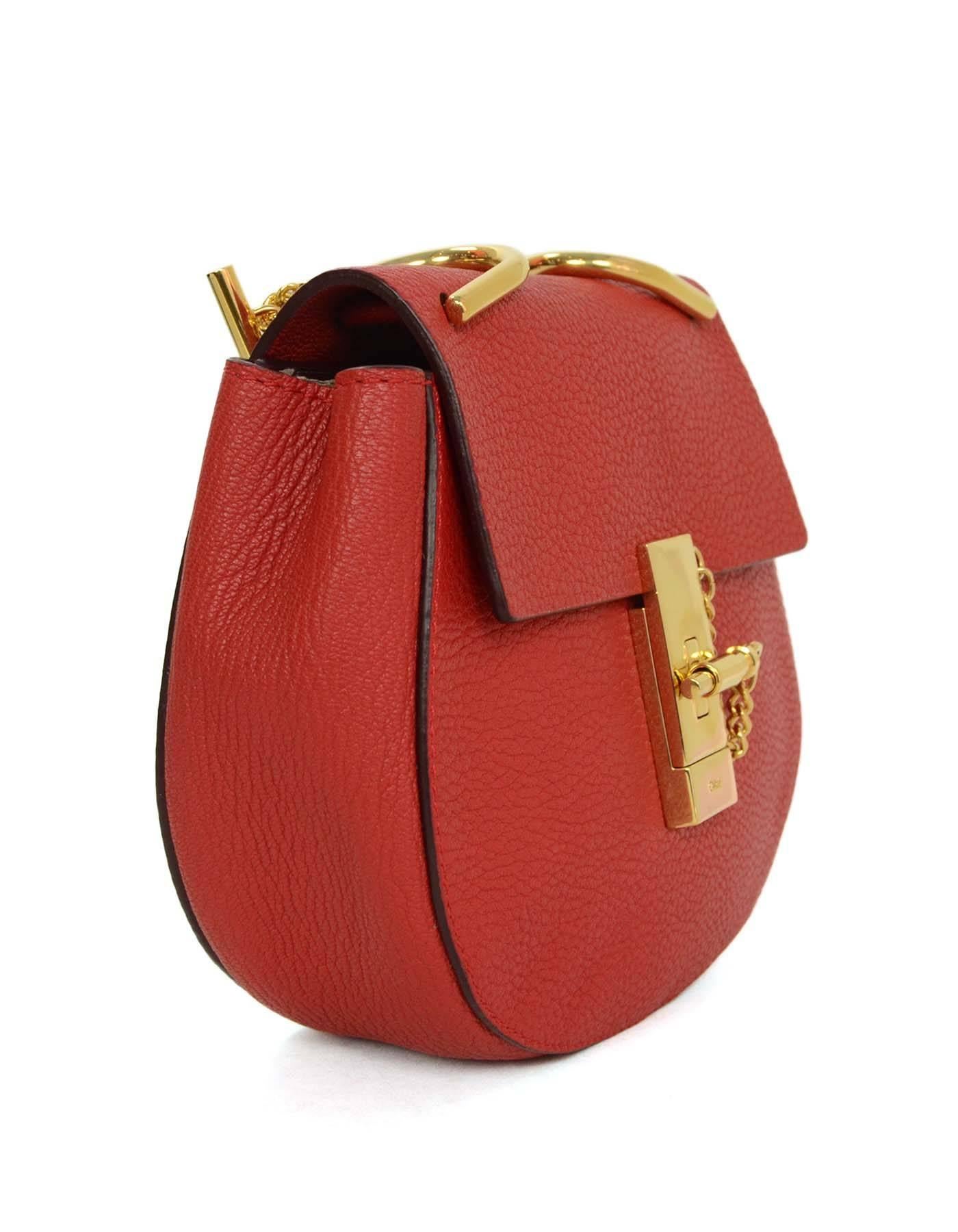 Chloe Red Leather Drew Mini Crossbody Bag GHW
Features mini saddle bag silhouette

Made In: Italy
Color: Red
Hardware: Gold
Materials: Leather
Lining: Tan suede
Closure/Opening: Flap top with turn-lock bar and chain closure
Exterior