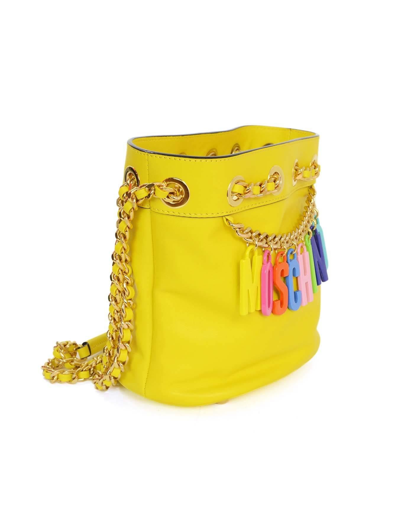Moschino Yellow Charm Bucket Bag
Features multi-colored Moschino letter charms with gold chain detailing

Made In: Italy
Color: Yellow
Hardware: Goldtone
Materials: Leather and metal
Lining: Yellow textile
Closure/opening: Open top with draw