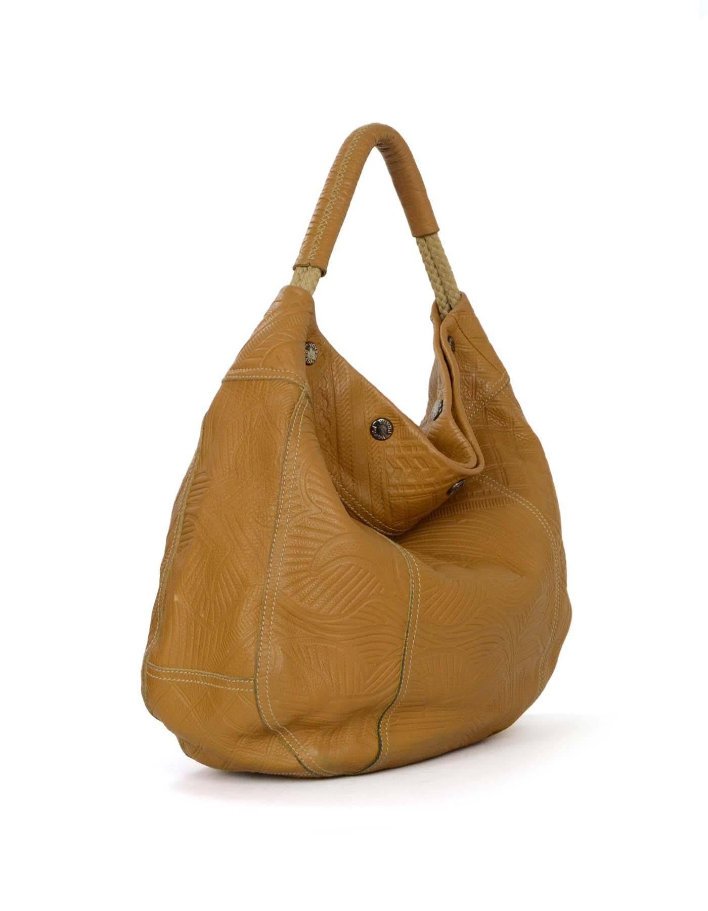 Prada Tan Embossed Hobo Bag
Features woven rope shoulder straps 

Made In: Italy
Color: Tan
Hardware: Gunmetal
Materials: Leather
Lining: Tan textile
Closure/Opening: Open top with button snap closure
Exterior Pockets: None
Interior