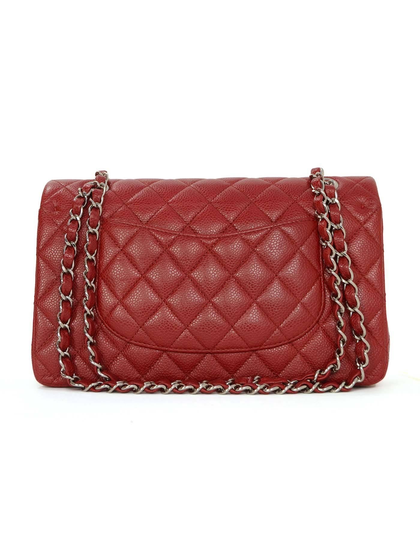 Chanel Red Caviar Medium Double Flap Bag
Features adjustable shoulder strap
Made In: France
Year of Production: 2011
Color: Red
Hardware: Silvertone
Materials: Caviar leather
Lining: Red leather
Closure/Opening: Double flap top with snap and