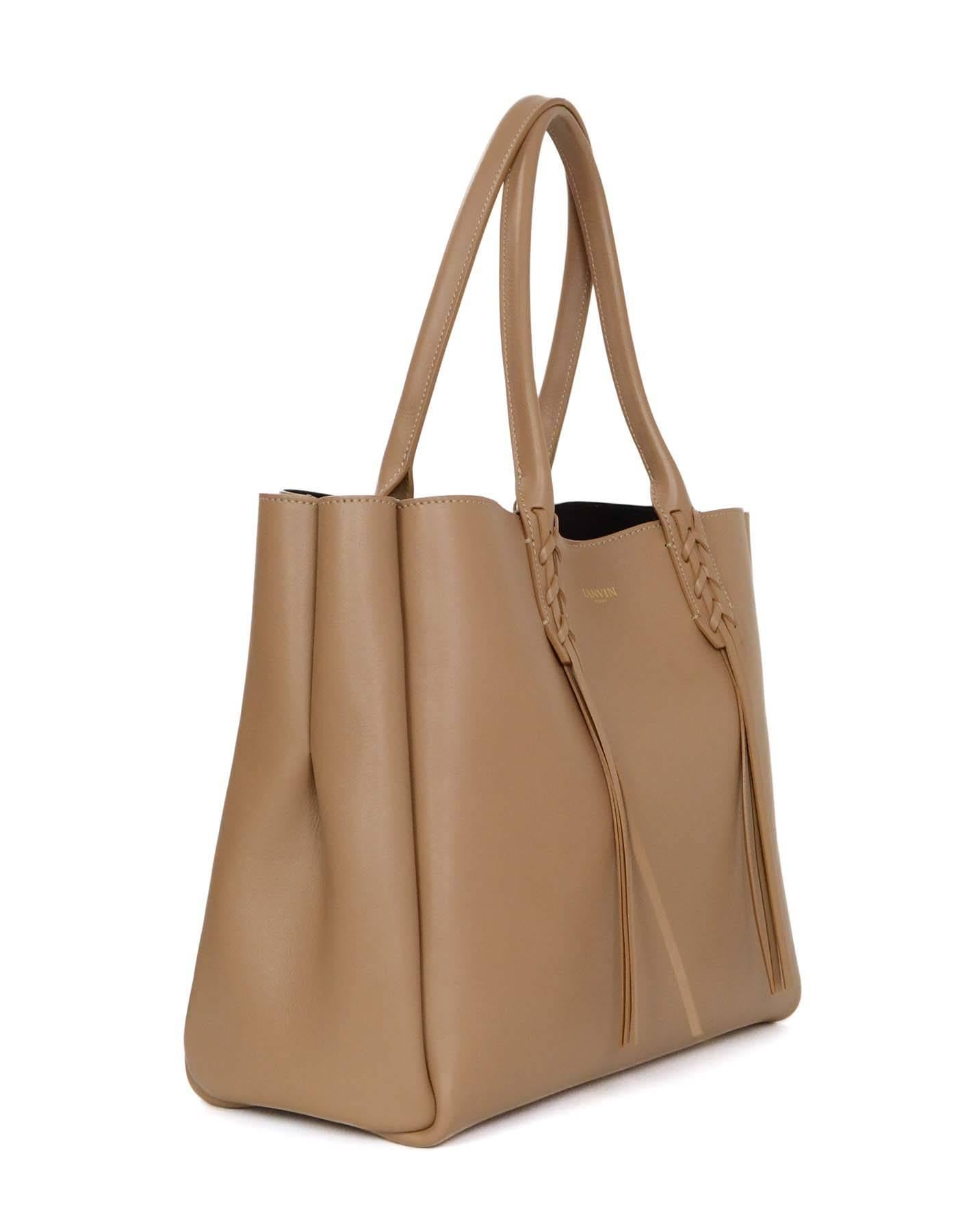 Lanvin Taupe Small Shopper Tote
Features fringed tassel detailing and removable zip pouch
Made In: Italy
Color: Taupe
Hardware: Goldtone
Materials: Leather 
Lining: Black suede
Closure/Opening: Open top with lobster clasp over