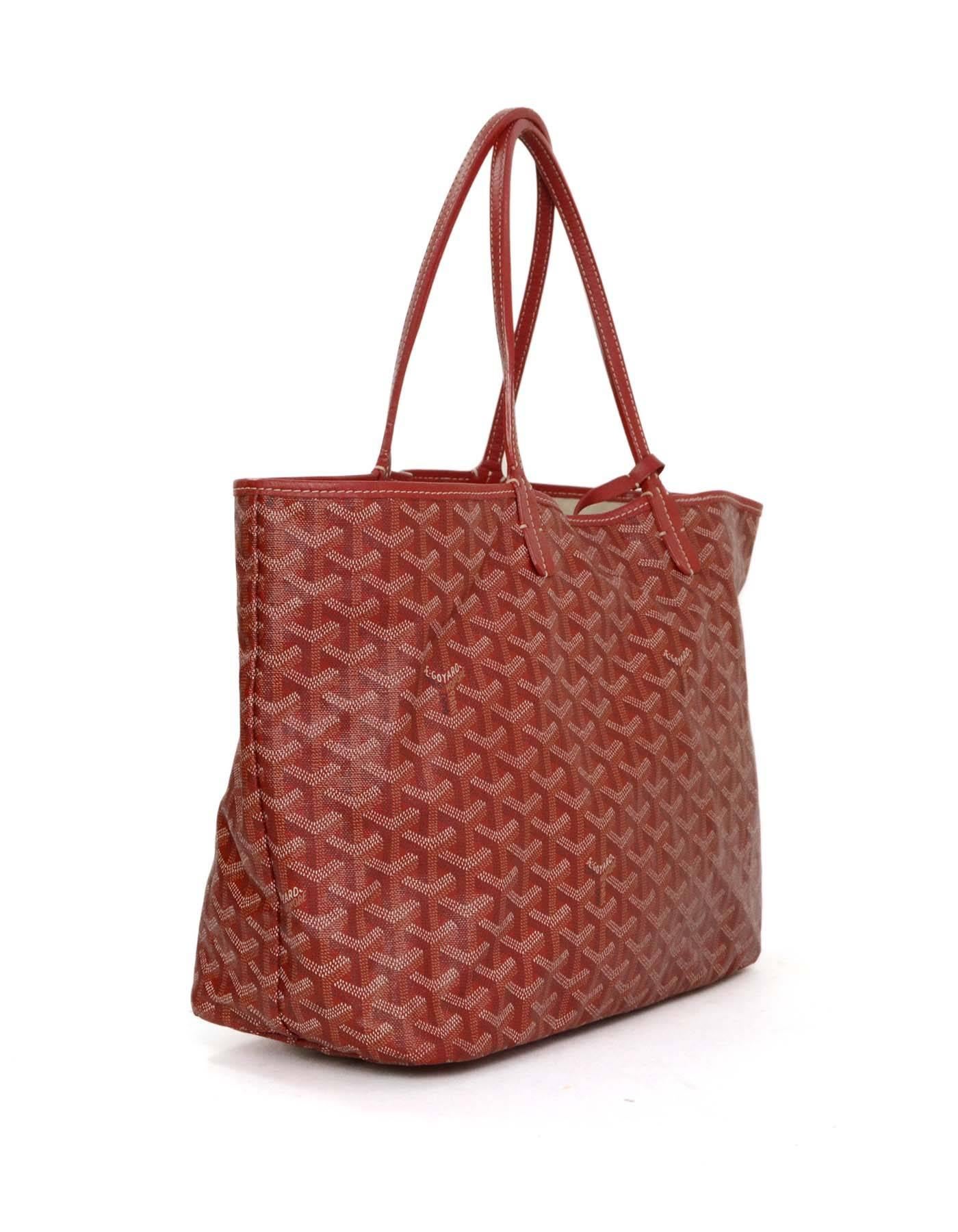 Goyard Red St. Louis MM Tote 
Made In: France
Color: Red and ivory
Hardware: Silvertone
Materials: Coated Canvas
Lining: Beige canvas
Closure/Opening: Open top
Exterior Pockets: None
Interior Pockets: One detachable insert pouch with flap