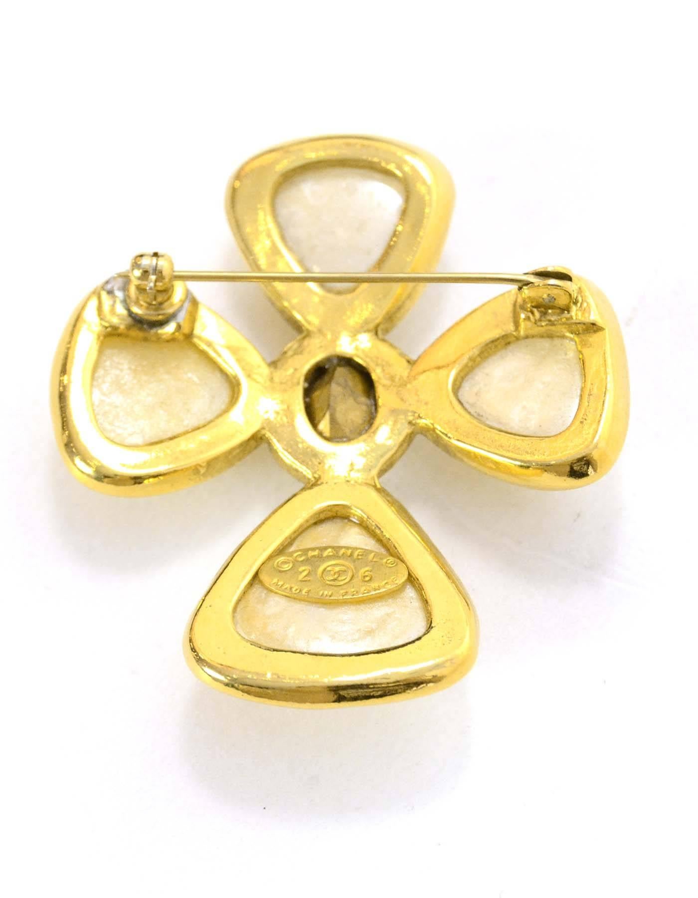 Chanel Pearl & Crystal Cross Brooch

Made In: France
Year of Production: 1987
Color: Ivory and goldtoone
Materials: Metal, faux pearl and crystal
Closure: Pin back closure
Stamp: 2 CC 6
Overall Condition: Very good vintage, pre-owned condition