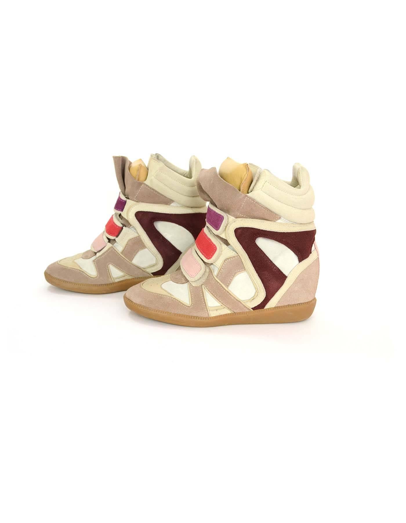 Isabel Marant Beige & Off White Bekket Sneakers sz 36
Features concealed wedge and multi-colored velcro straps

Color: Beige, off white and multi-colored
Materials: Suede and rubber
Closure/Opening: Velcro closure
Sole Stamp: Isabel Marant