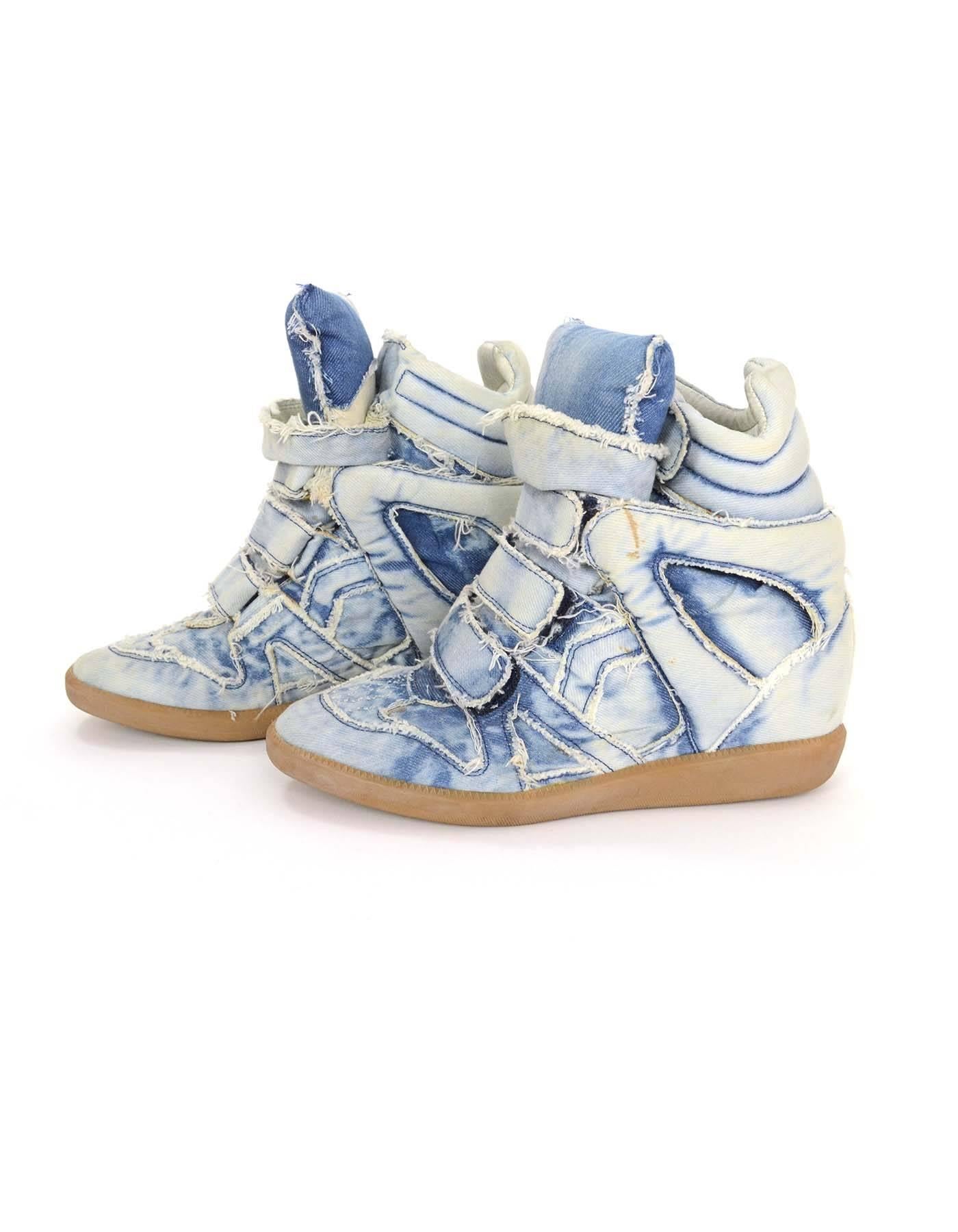 Isabel Marant Blue Denim Bekket Sneakers sz 37
Features concealed wedge and frayed acid washed denim 
Color: Acid wash blue
Materials: Denim and rubber
Closure/Opening: Velcro closure
Sole Stamp: Isabel Marant 37
Retail Price: $680 +