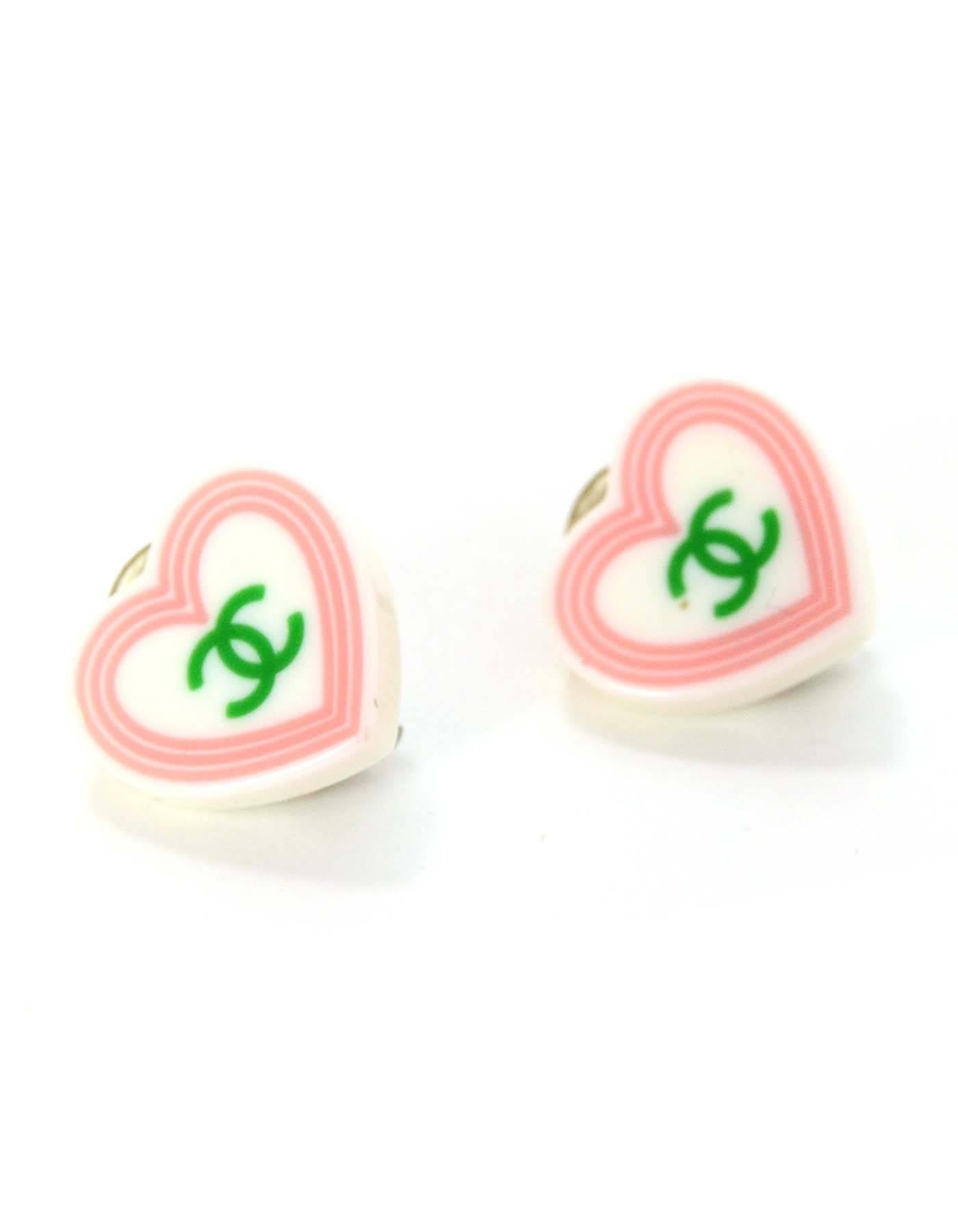 Chanel Heart Shape CC Clip On Earrings
Feature a green CC logo with a pink outlined border 
Made In: France
Year of Production: 2004
Stamp: 04 CC 
Closure: Clip on
Color: White, pink and green
Materials: Plastic and metal 
Overall Condition: