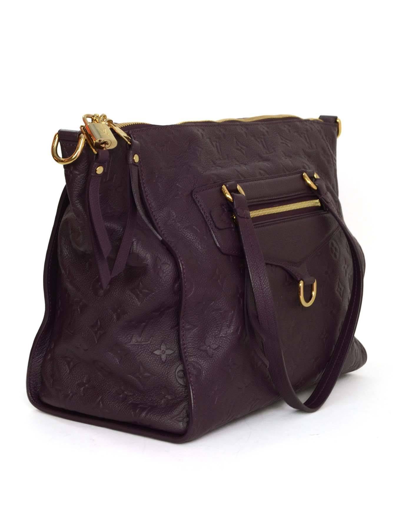 Louis Vuitton Aube Purple Monogram Empreinte Lumeniuse PM Tote 
Features optional shoulder/crossbody strap
Made In: France
Year of Production: 2011
Color: Aube purple
Hardware: Goldtone
Materials: Leather
Lining: Purple with black stripes