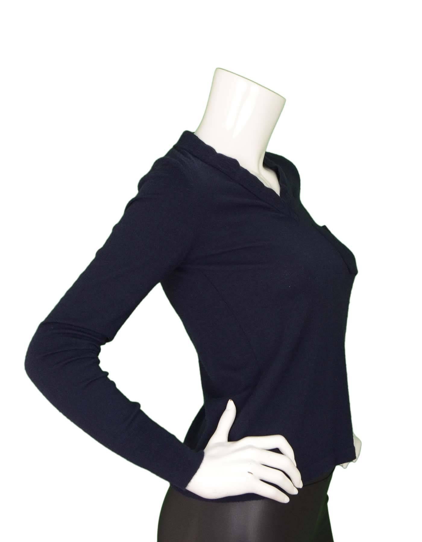 Chanel Navy Cashmere Sweater 
Features breast patch pocket with stitched flower on it
Made In: Italy
Color: Navy
Composition: 93% cashmere, 7% polyester
Lining: None
Closure/Opening: None
Exterior Pockets: One breast patch pocket
Interior